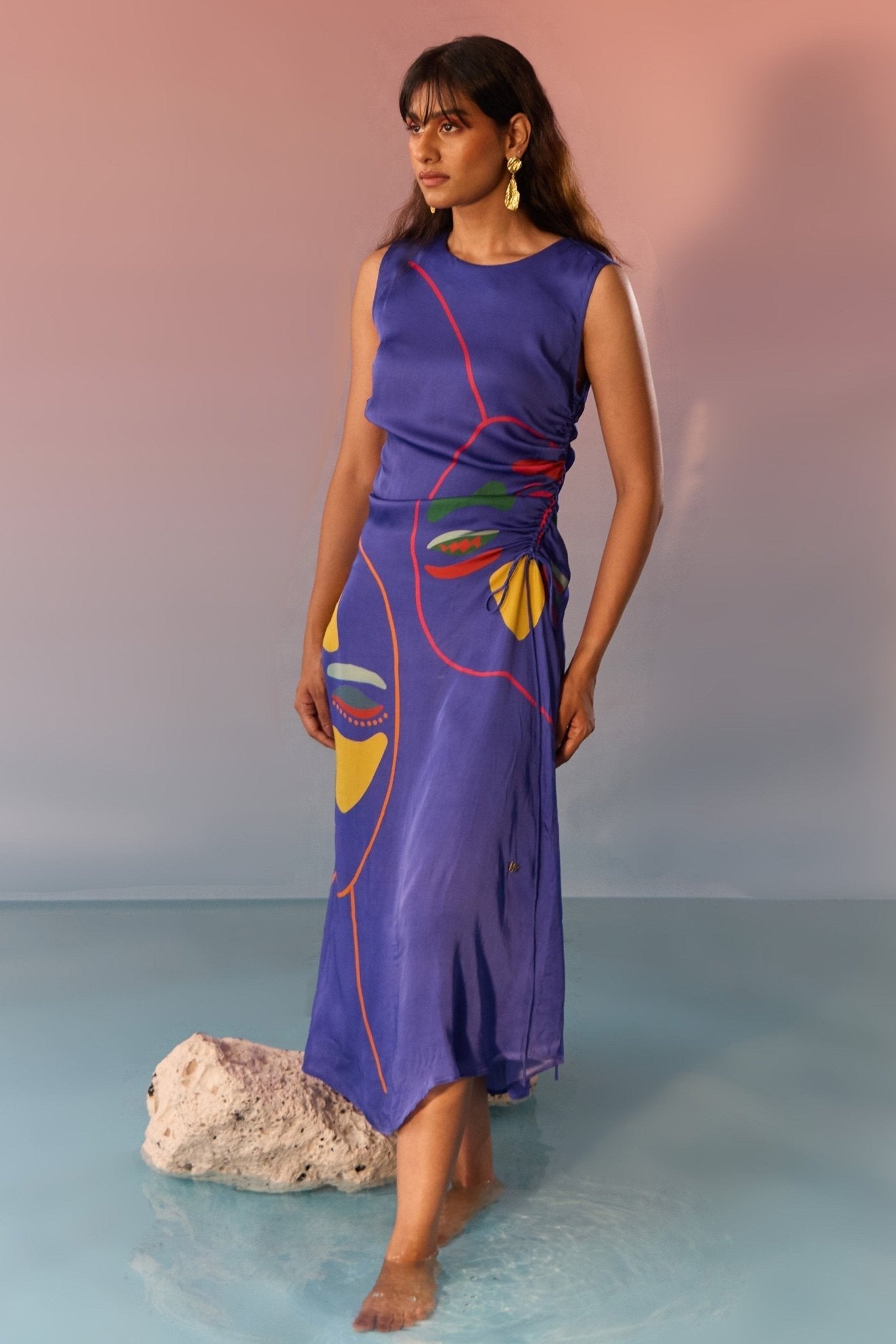Woman wearing a navy yin yang print dress by Stylera with colorful abstract face design