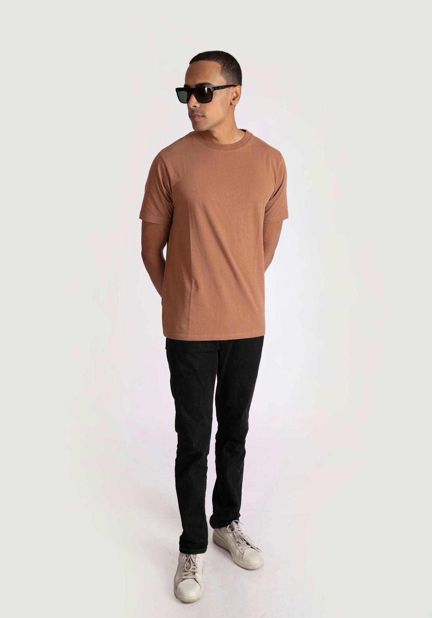 Man wearing Stylera brown regular fit casual tee with black pants and sunglasses