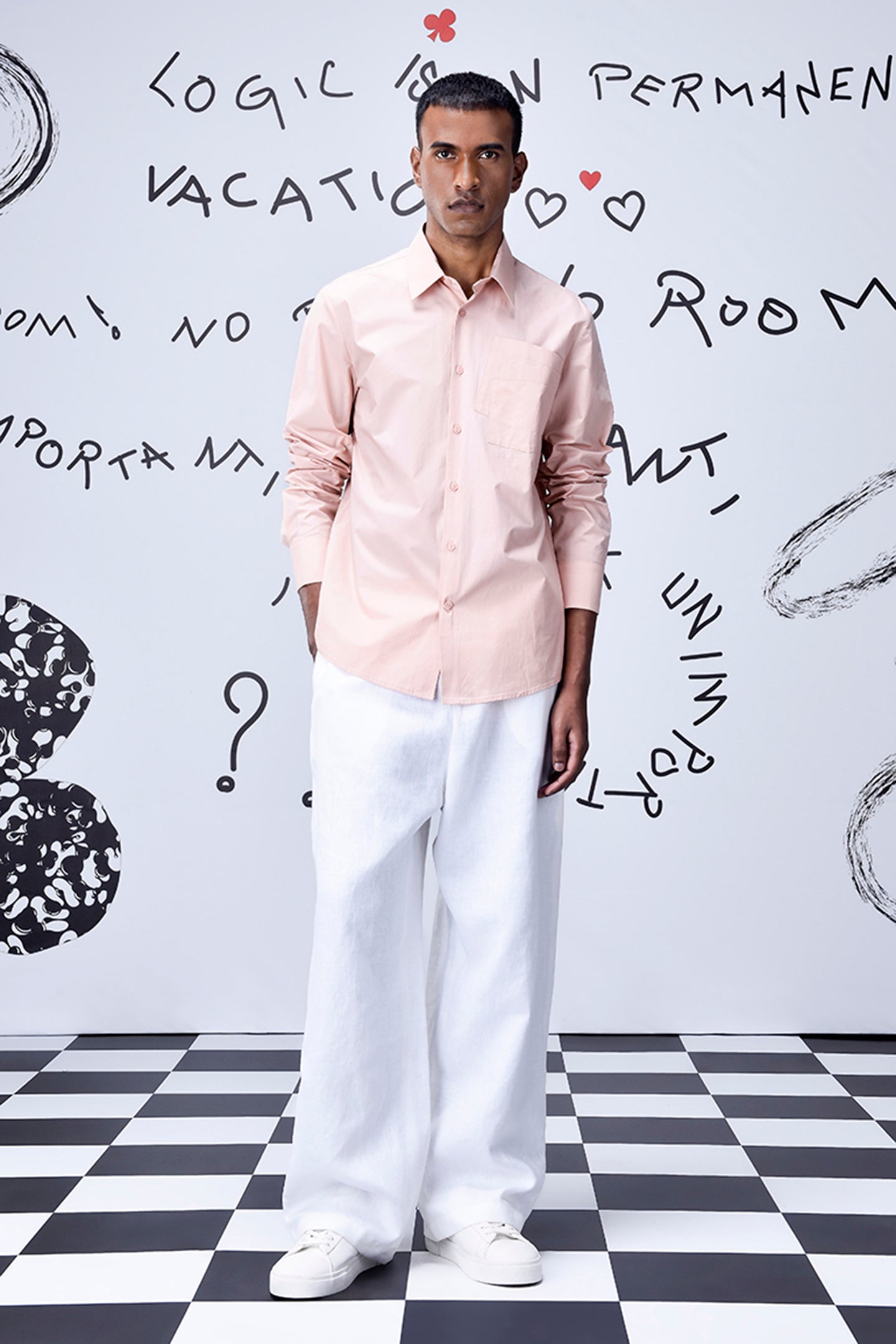 Stylera overlapping pocket shirt in light pink worn by male model with white pants