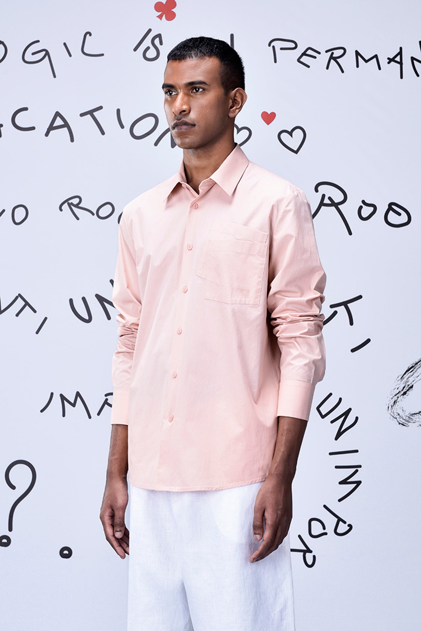 Stylera pink overlapping pocket shirt worn by male model with white pants