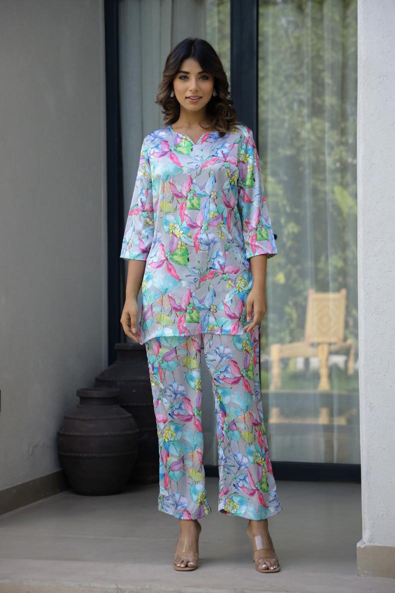 Pastel floral satin pajama set from Stylera with colorful butterfly print and relaxed fit