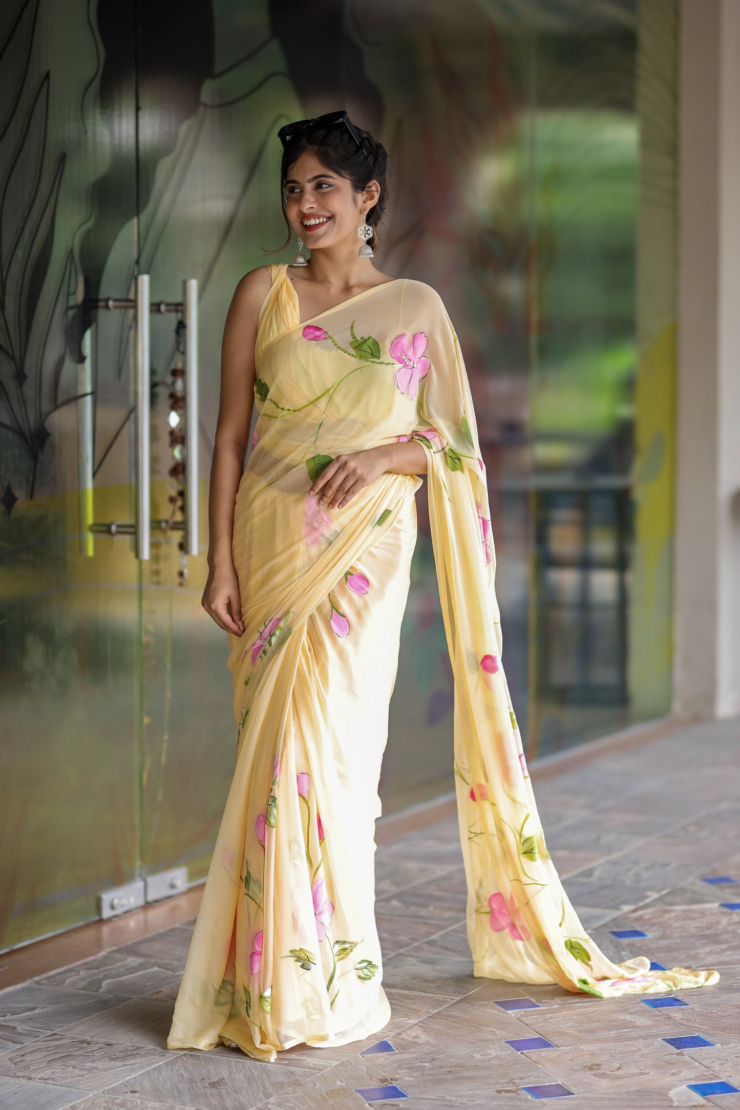 Pastel yellow floral saree for women showcased on a model with elegant floral patterns
