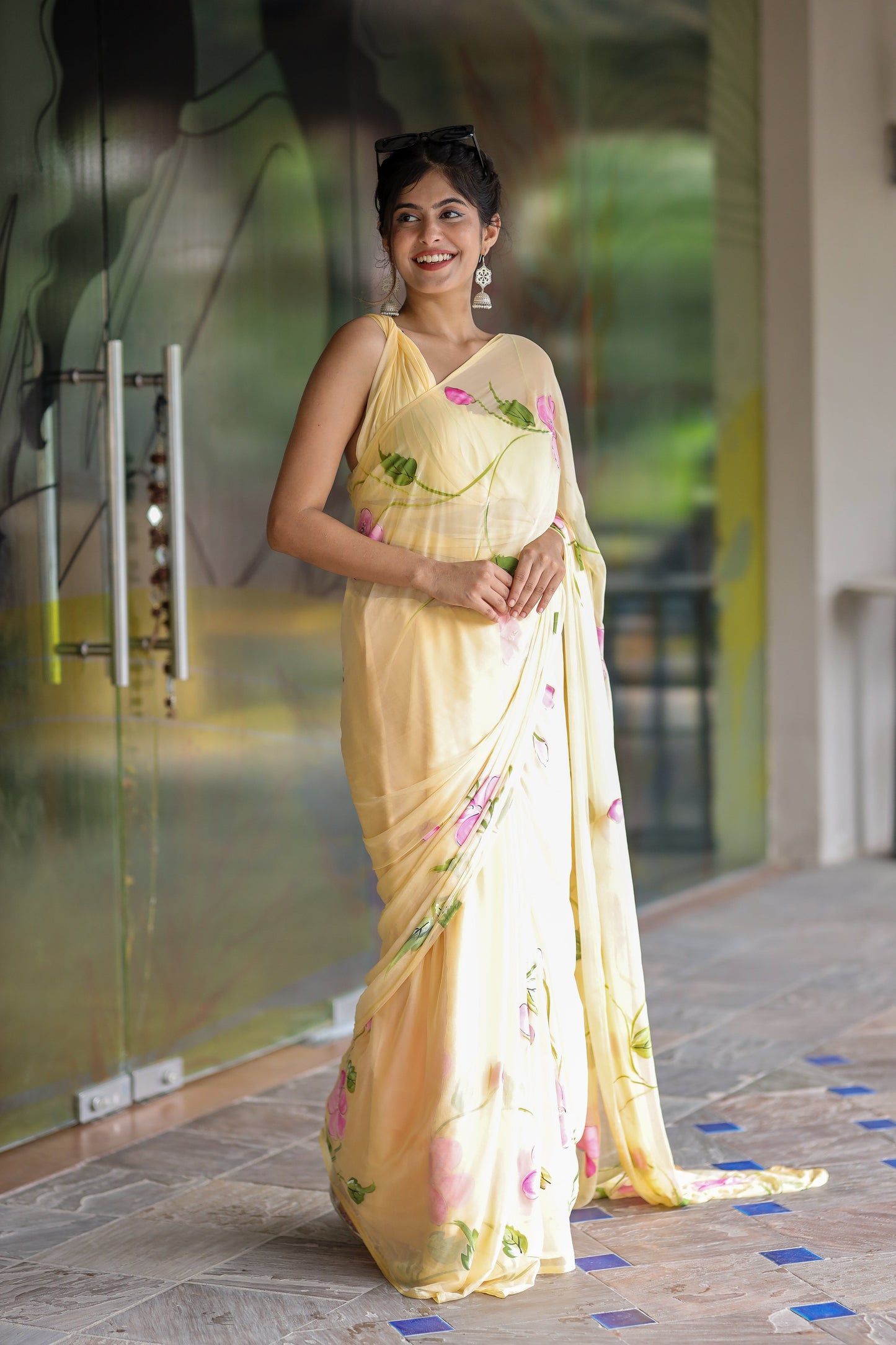 Elegant pastel yellow floral saree for women draped beautifully on a model outdoors