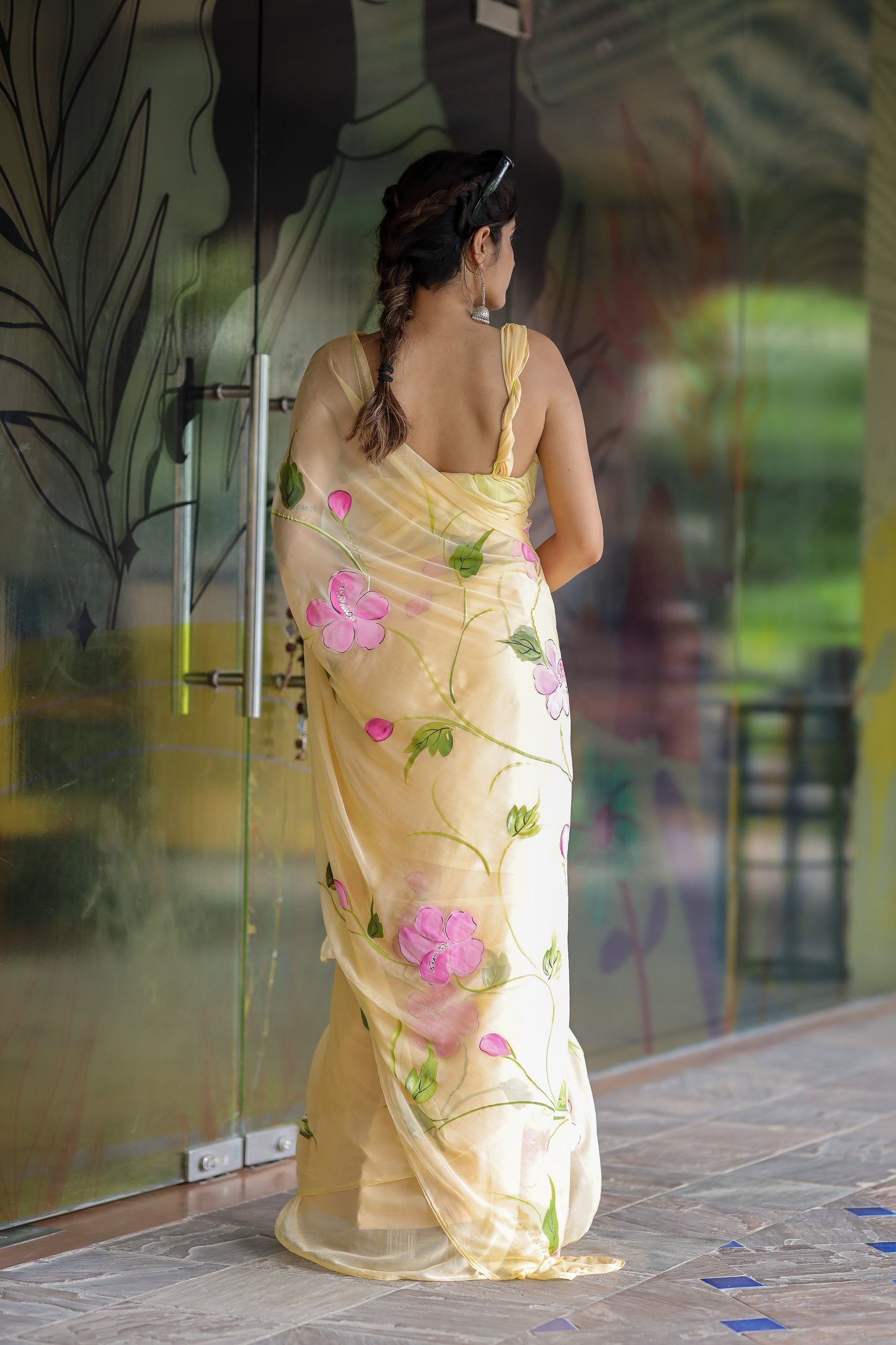 Elegant pastel yellow floral saree for women with vibrant pink flowers and delicate embroidery
