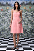 Peach casual dress with lace up front by Stylera worn by model with black hair