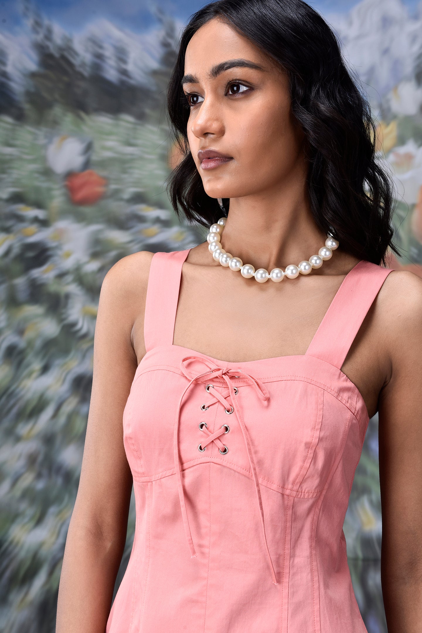 Woman wearing a peach casual dress with lace up front by Stylera