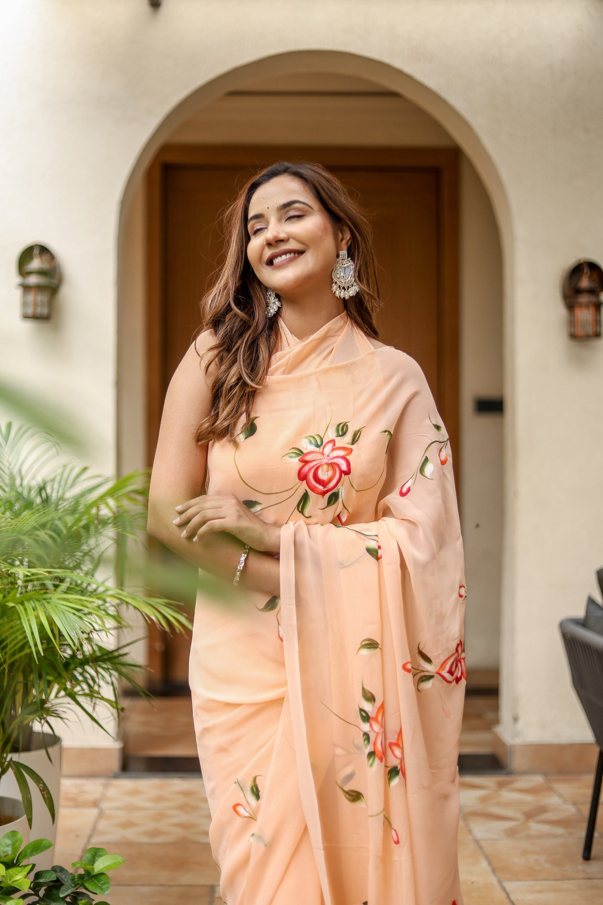 Elegant peach floral saree for women with intricate embroidery, perfect for festive occasions