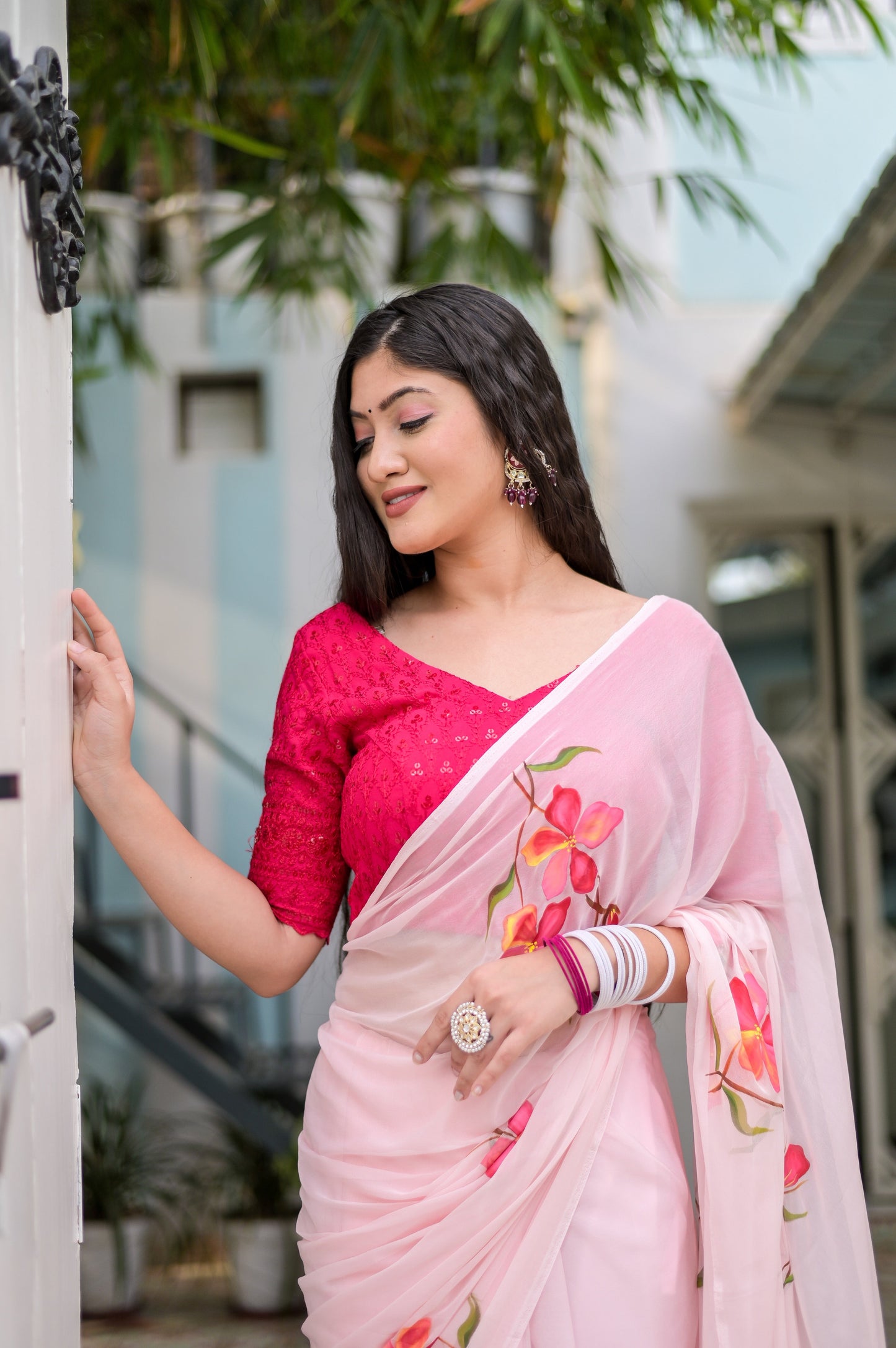 Elegant pink saree for women with floral prints and paired with a stylish blouse