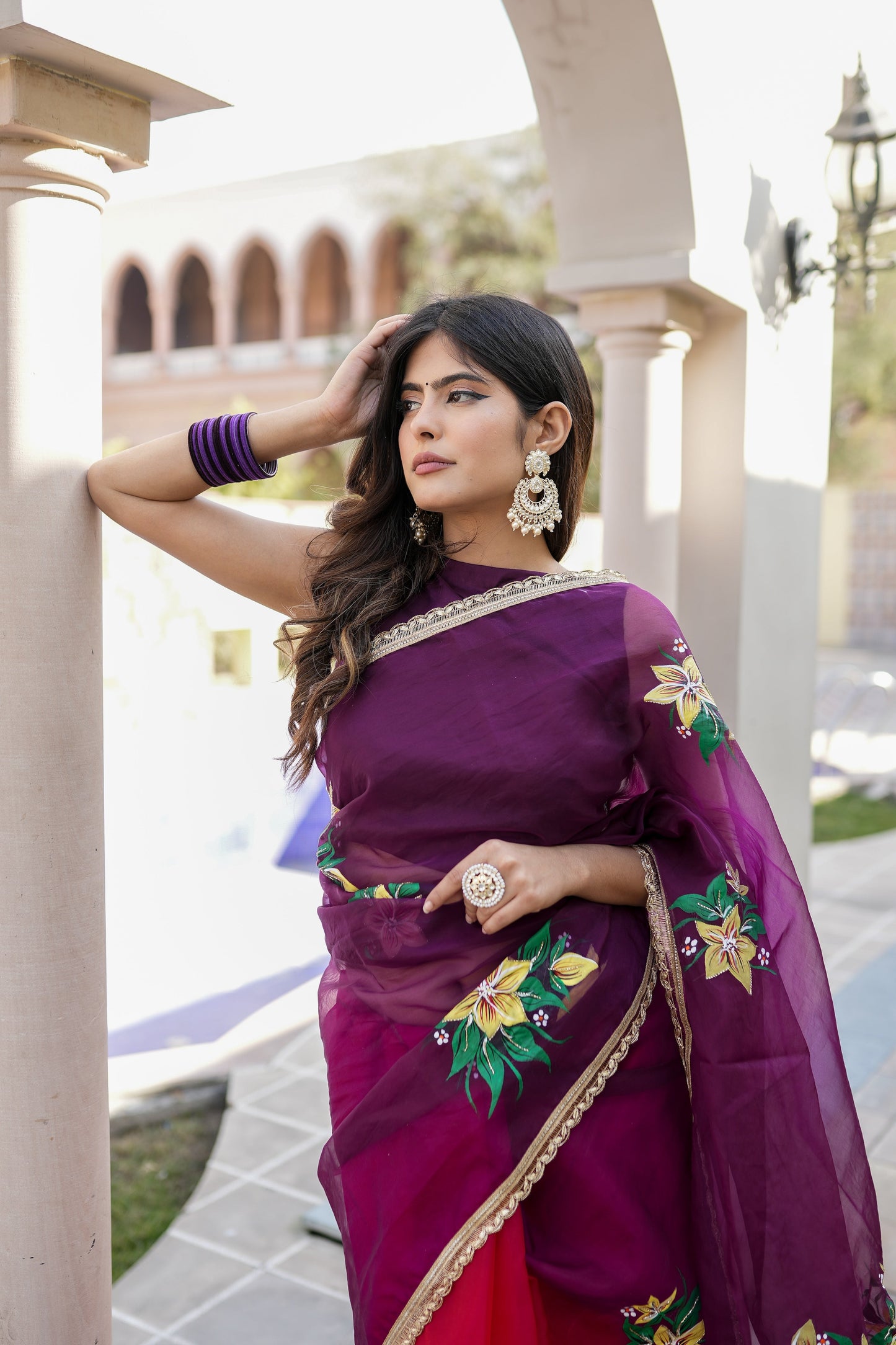 Elegant red and purple saree with handwork displayed on a model, perfect for festive occasions