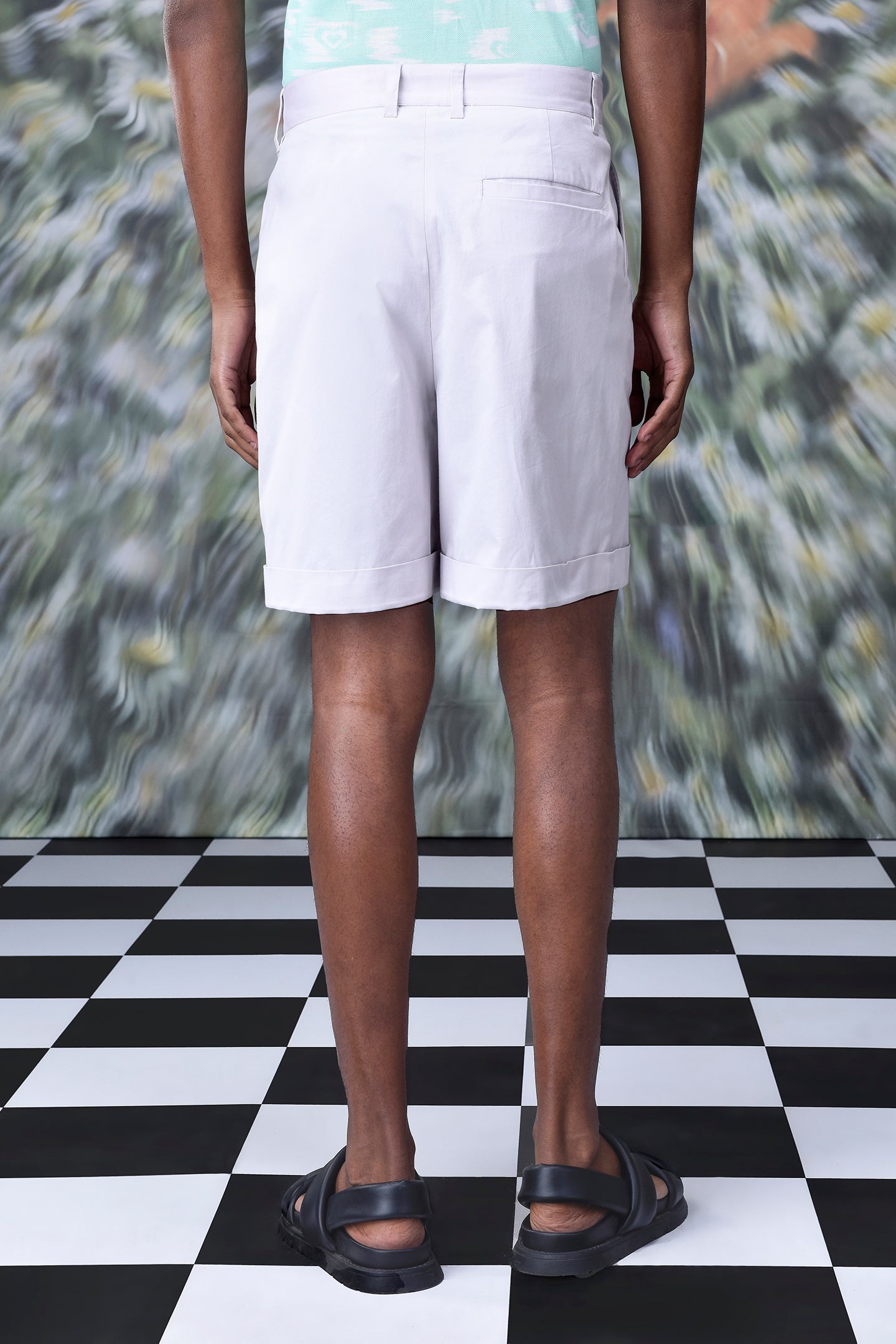 Stylera regular fit pearl grey shorts shown from back on a male model with black sandals