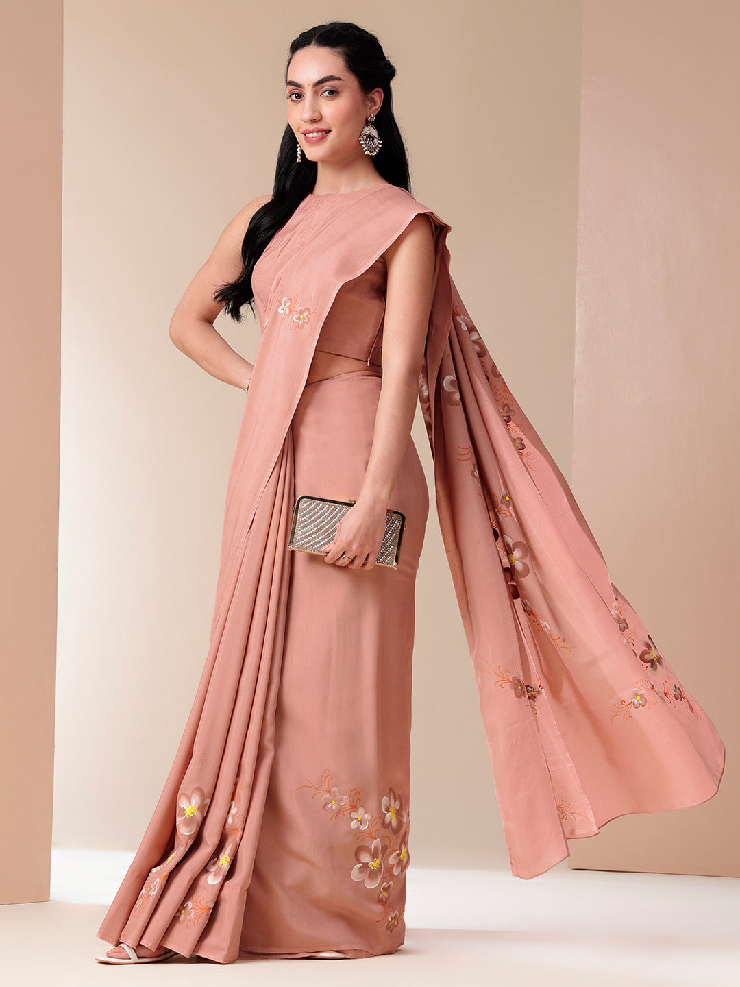 Elegant soft cotton saree with floral design in blush pink, paired with matching blouse and sleek accessories