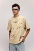 Stylera beige oversized stencil art t-shirt with abstract cutout print worn by male model