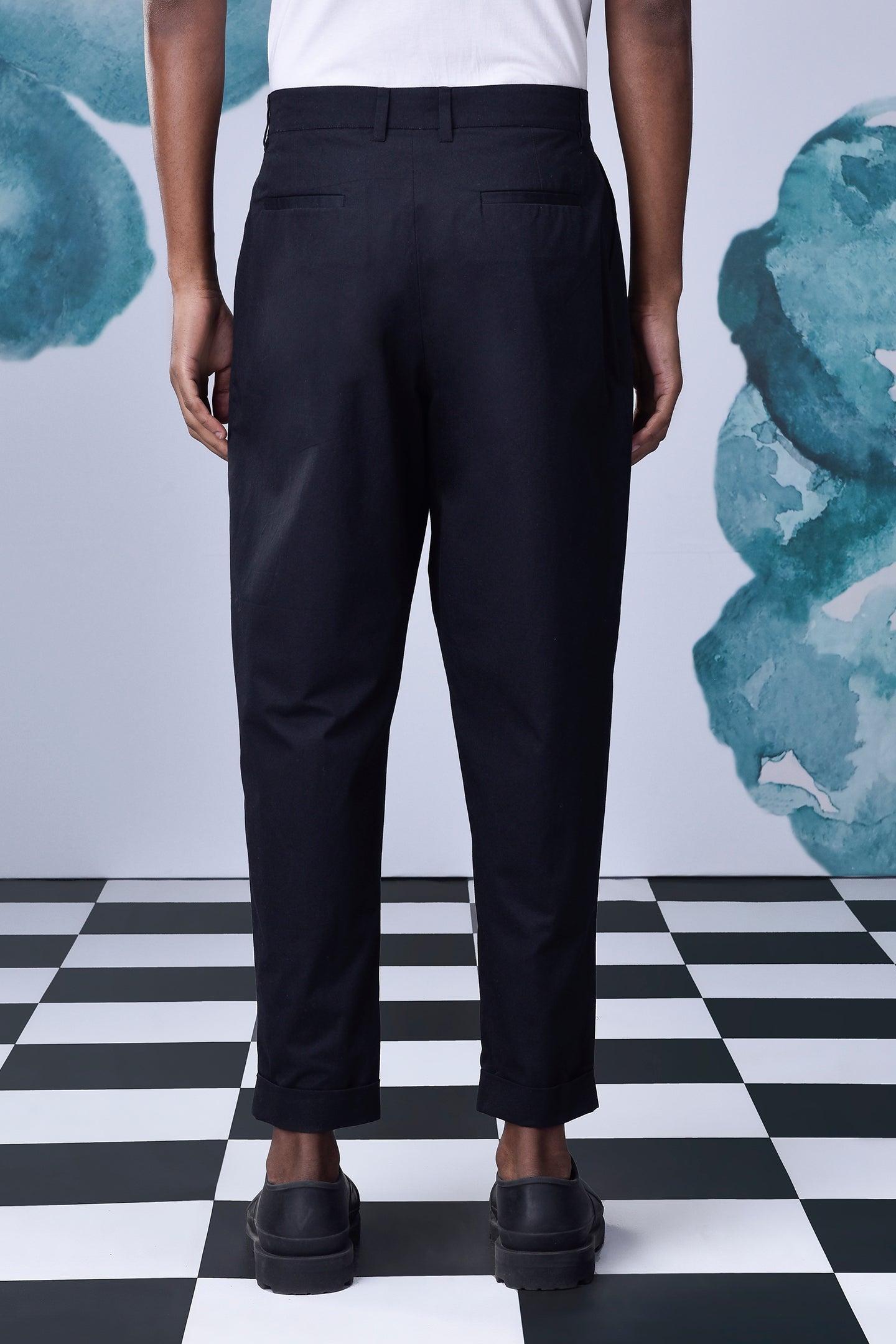 Back view of stylish black pants for work by Stylera worn with black shoes