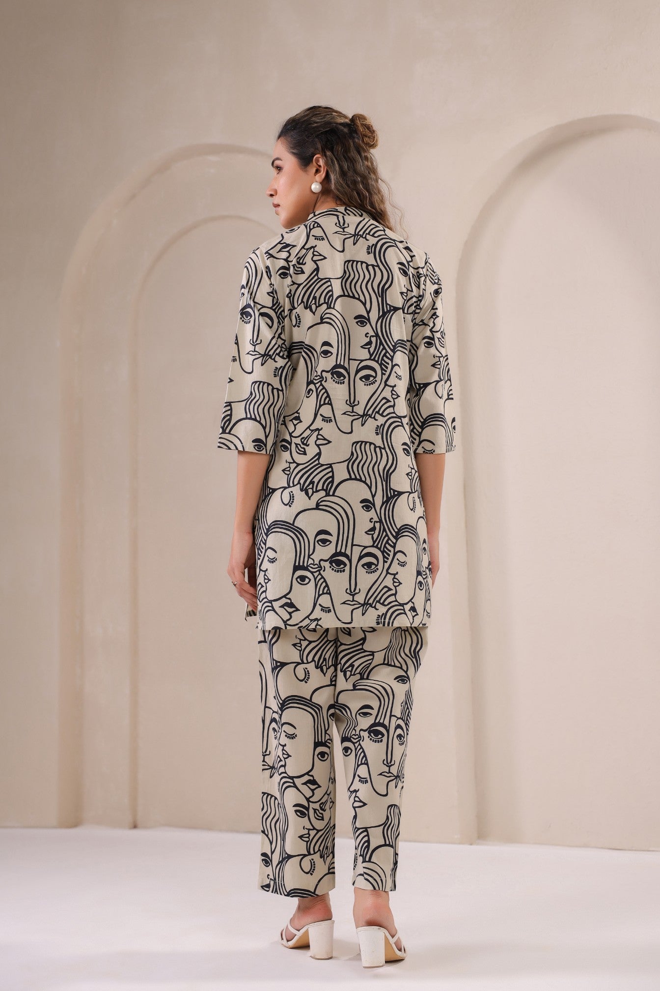 Back view of a stylish co-ord outfit for women featuring artistic face prints by Stylera
