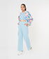 Trendy model wearing stylish co ord sets for women, featuring a floral bomber jacket and light blue pants