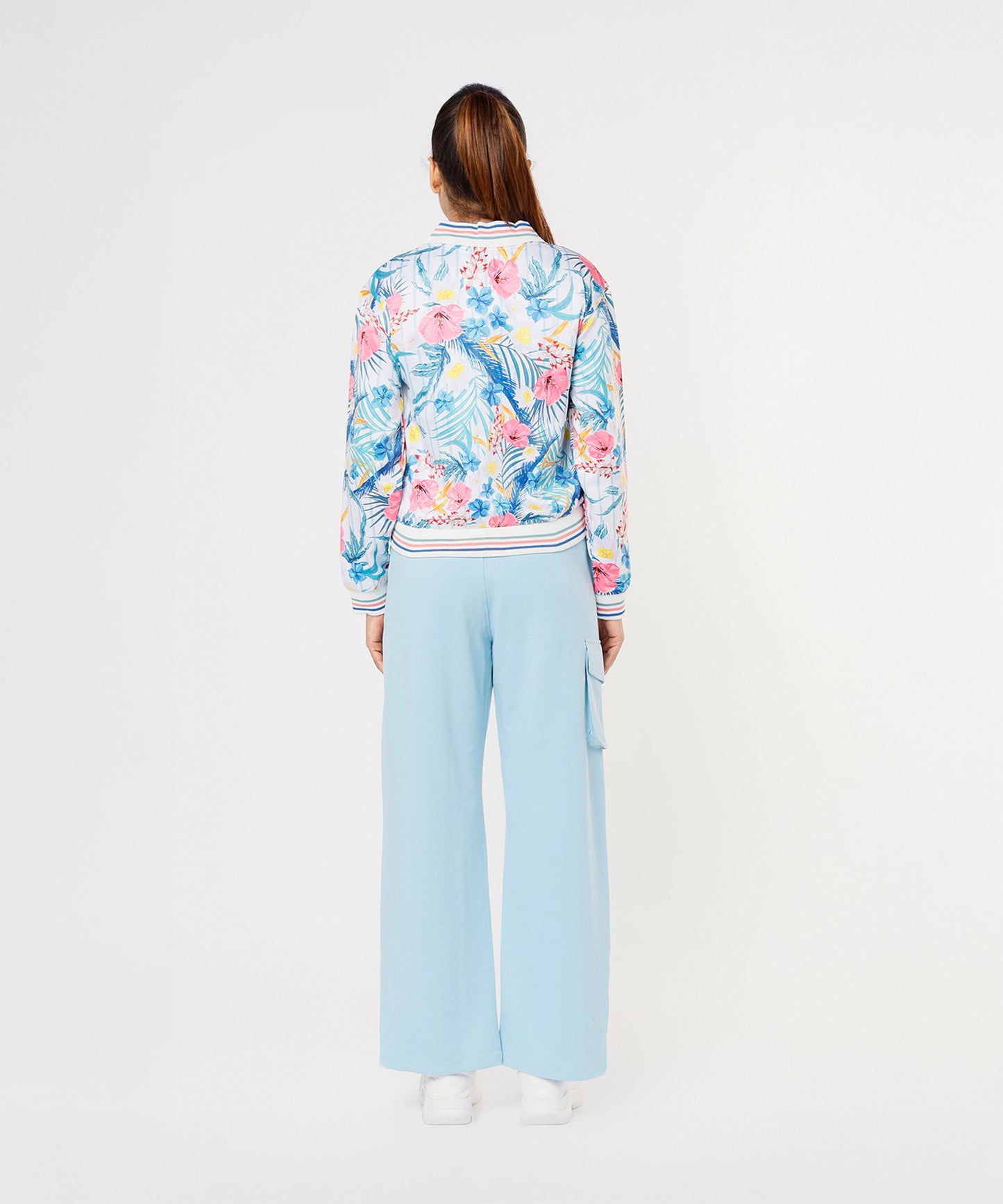Back view of a woman wearing a floral jacket and light blue pants, showcasing stylish co ord sets for women