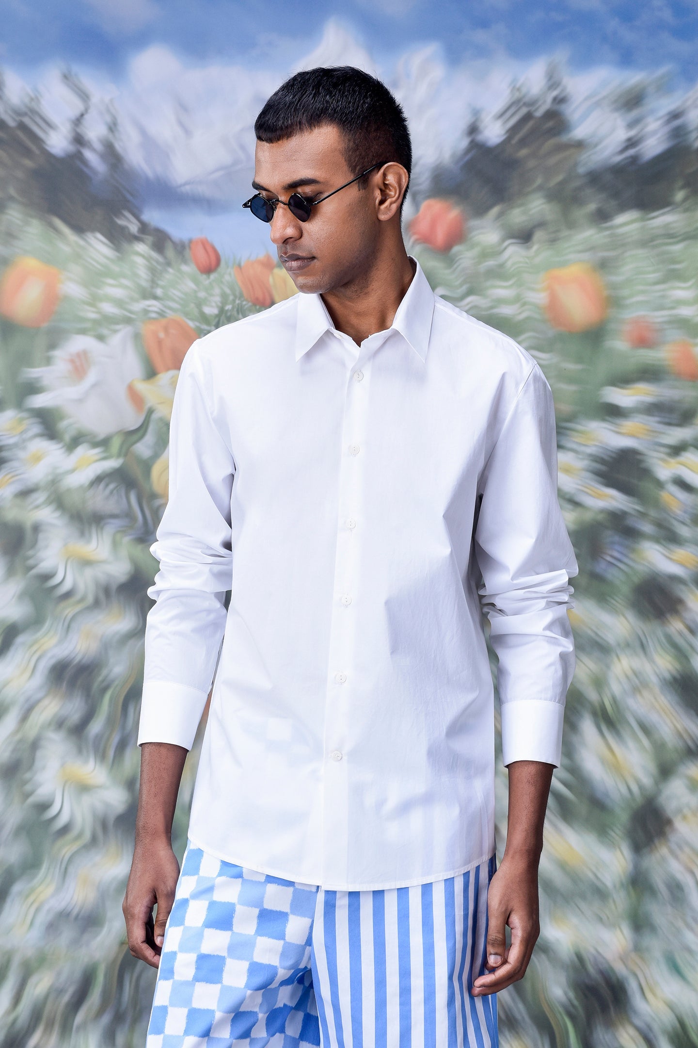 Stylish white shirt for men by Stylera worn with blue patterned pants