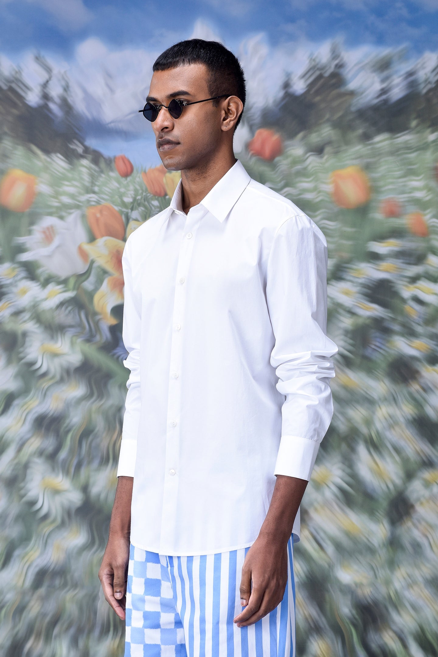 Stylish white shirt for men by Stylera worn with blue striped pants