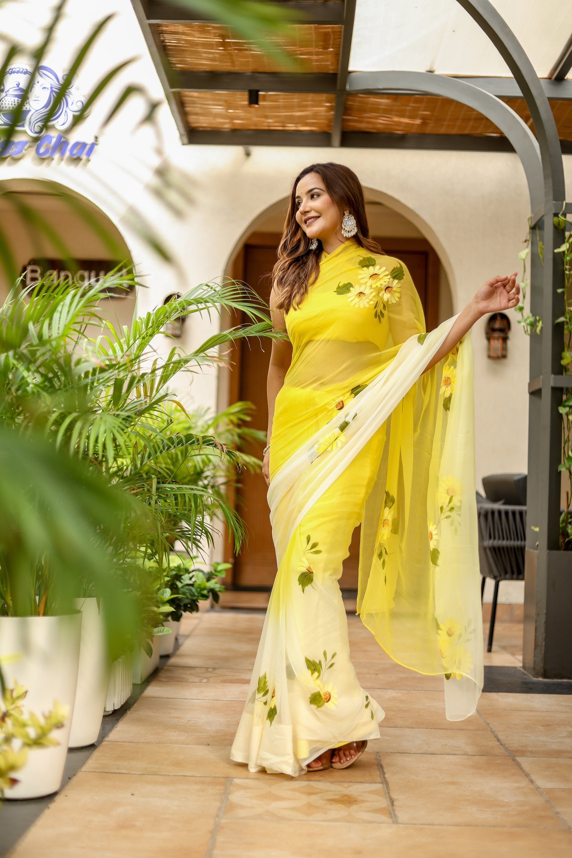 Elegant sunflower saree for women in yellow with floral accents, perfect for festive occasions