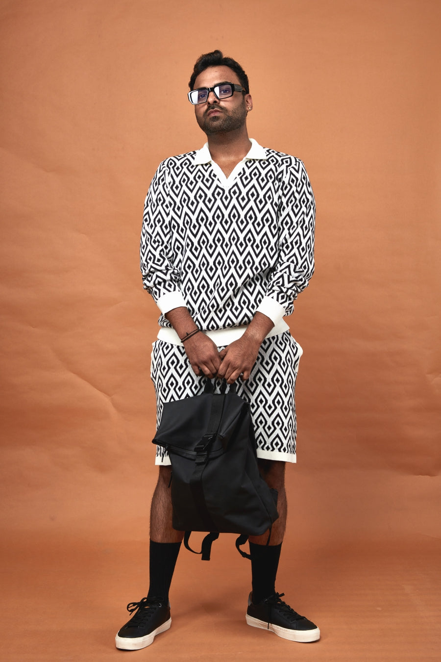 Stylish model wearing a knit polo with a trendy pattern, ideal as a trendy casual polo for men