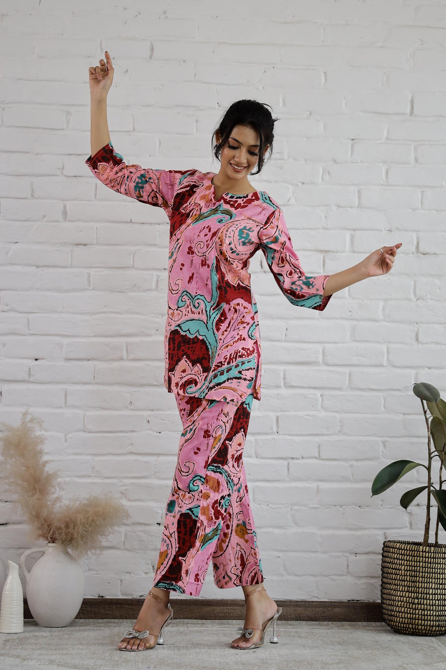 Model wearing a trendy cotton two piece outfit featuring vibrant colors and bold patterns