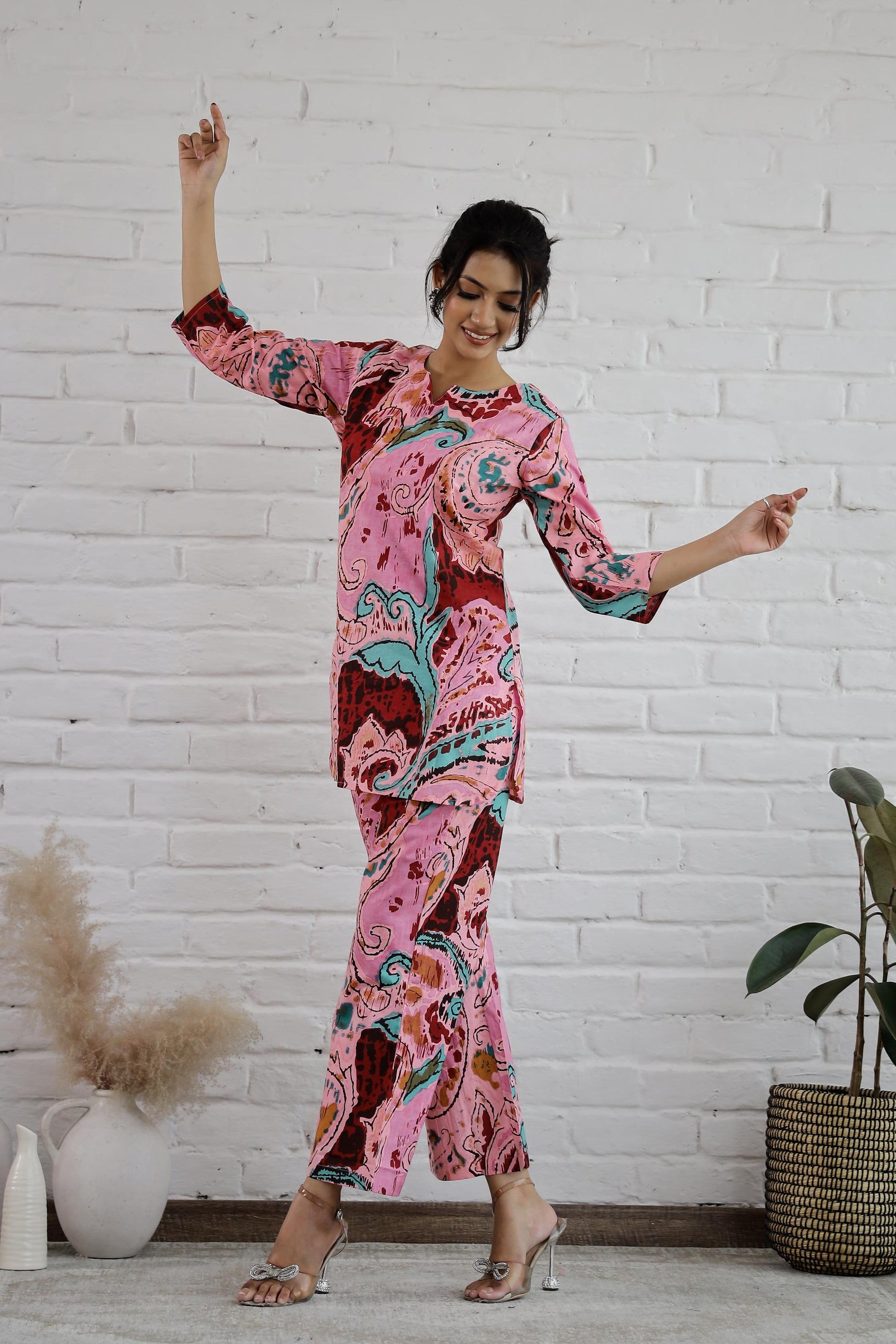 Model wearing a trendy cotton two piece outfit featuring vibrant colors and bold patterns