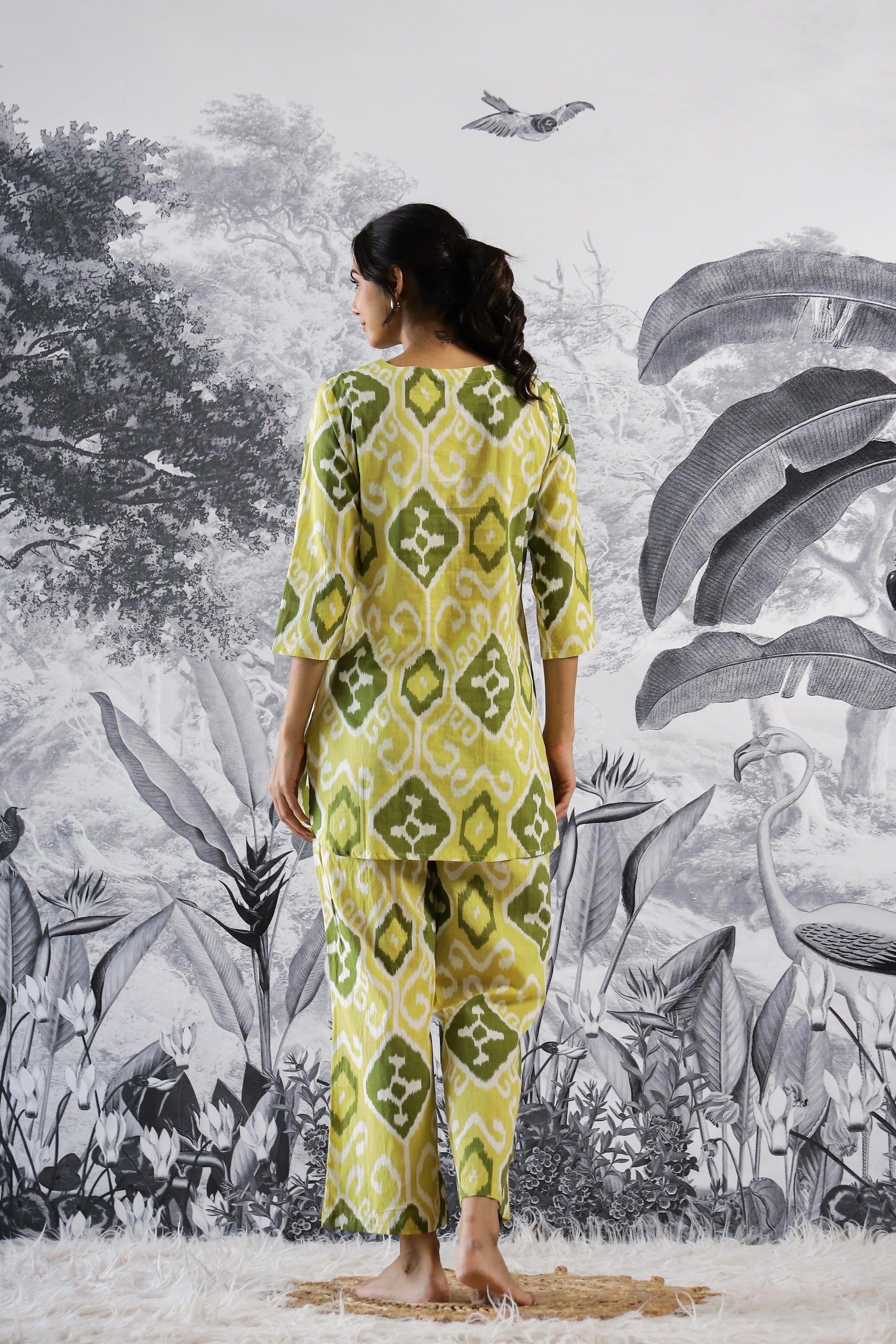 Woman wearing a Stylera trendy cotton two piece outfit with a vibrant green and yellow pattern