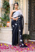 Trendy elegant party wear saree in black with floral design and embellished border for festive occasions