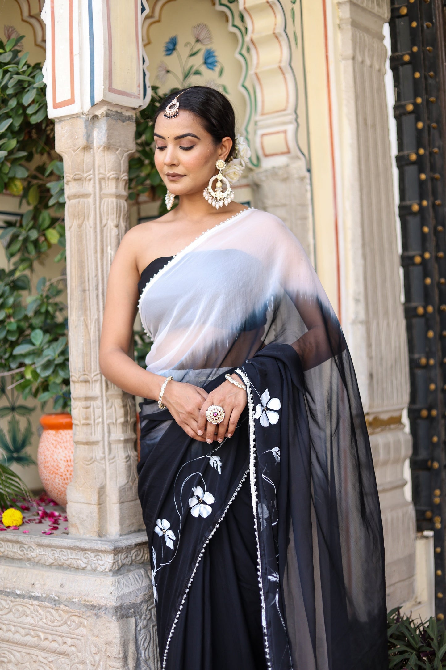 Trendsetting elegant party wear saree in black with floral embroidery and draped style