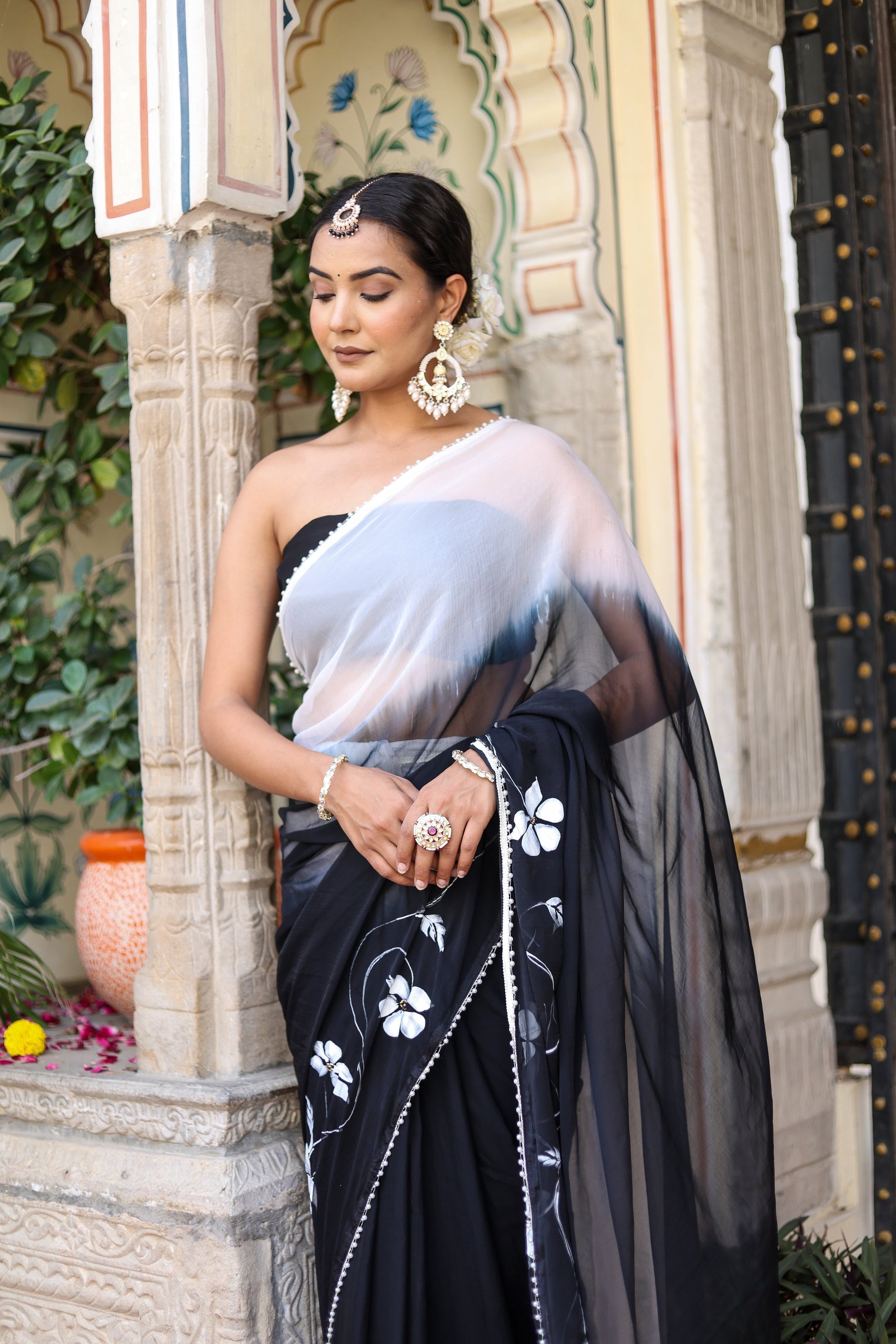 Trendsetting elegant party wear saree in black with floral embroidery and draped style