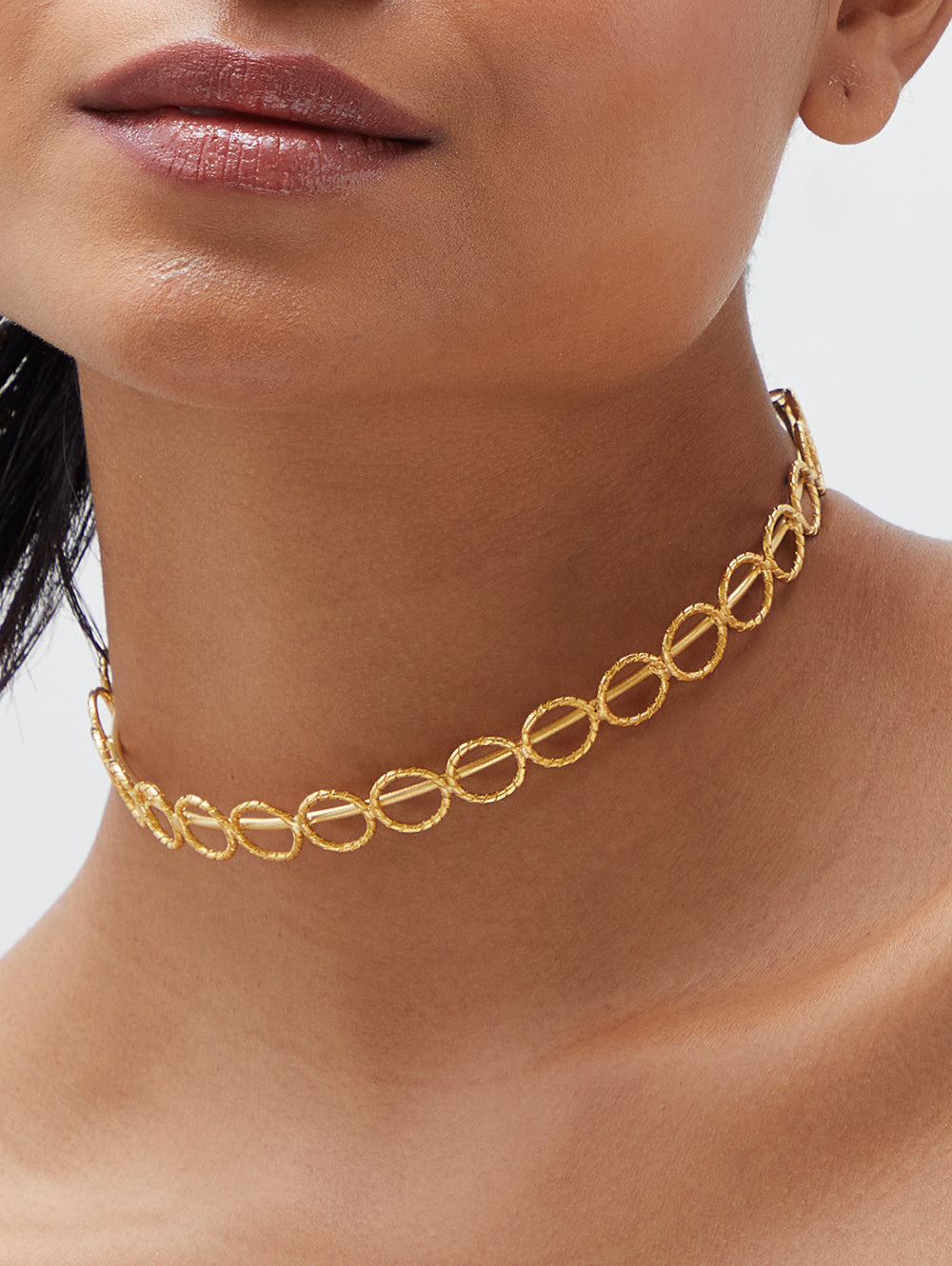 Stylera gold choker necklace with textured circular links on model neck trendy gold accessories