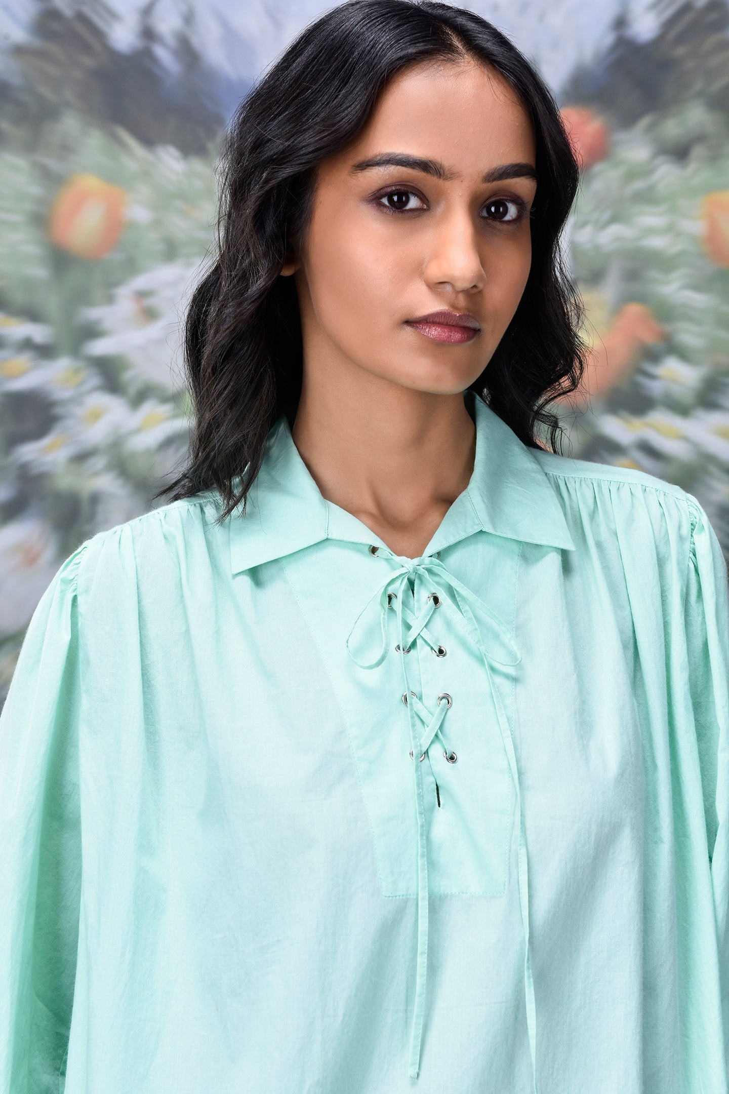 Stylera mint green collared shirt with lace up front and billowy sleeves trendy loose fit women's top on model