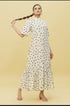Model wearing Stylera white polka dot trendy midi dress for women with high neck puff sleeves and ruffle hem