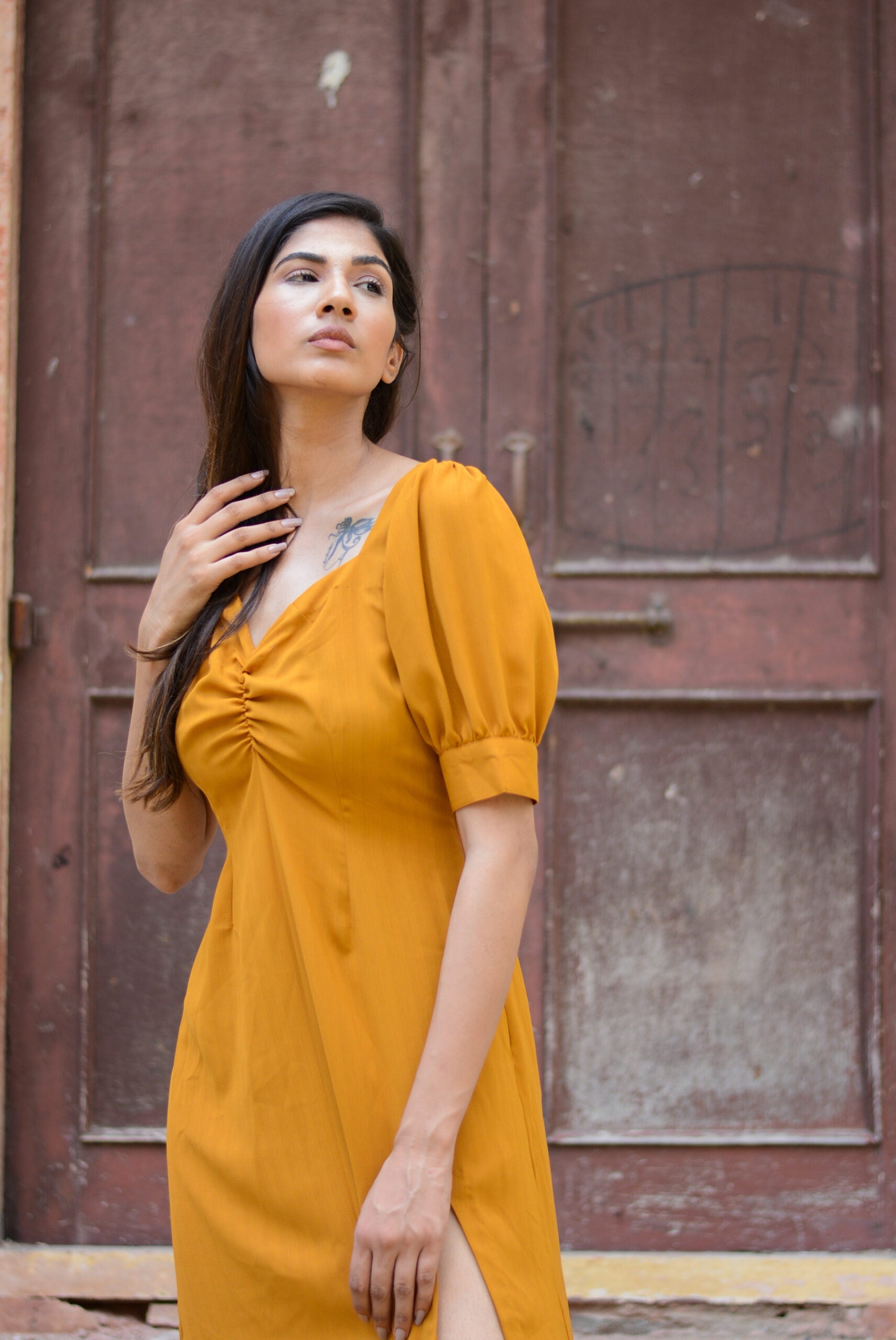 Trendy yellow slit midi dress with puff sleeves and a ruched bodice for a stylish look