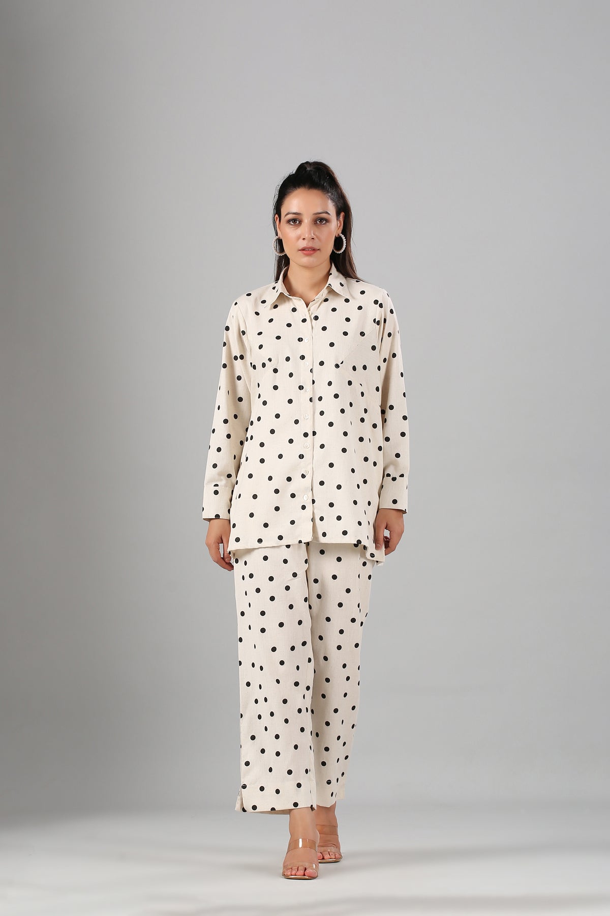Woman modeling Stylera two piece outfit polka dots cream button up long sleeve top with matching pants