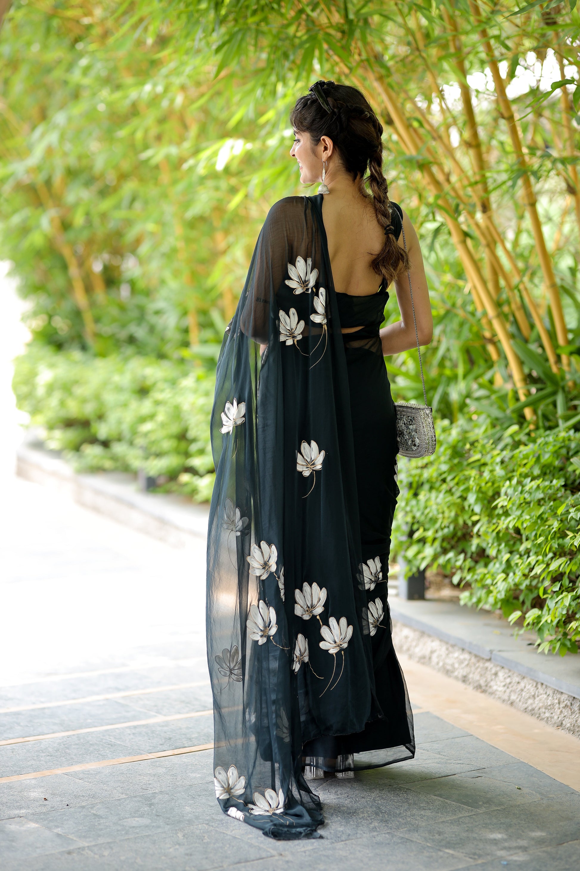 Elegant unique black saree for party wear featuring floral embroidery and a flowing sheer dupatta