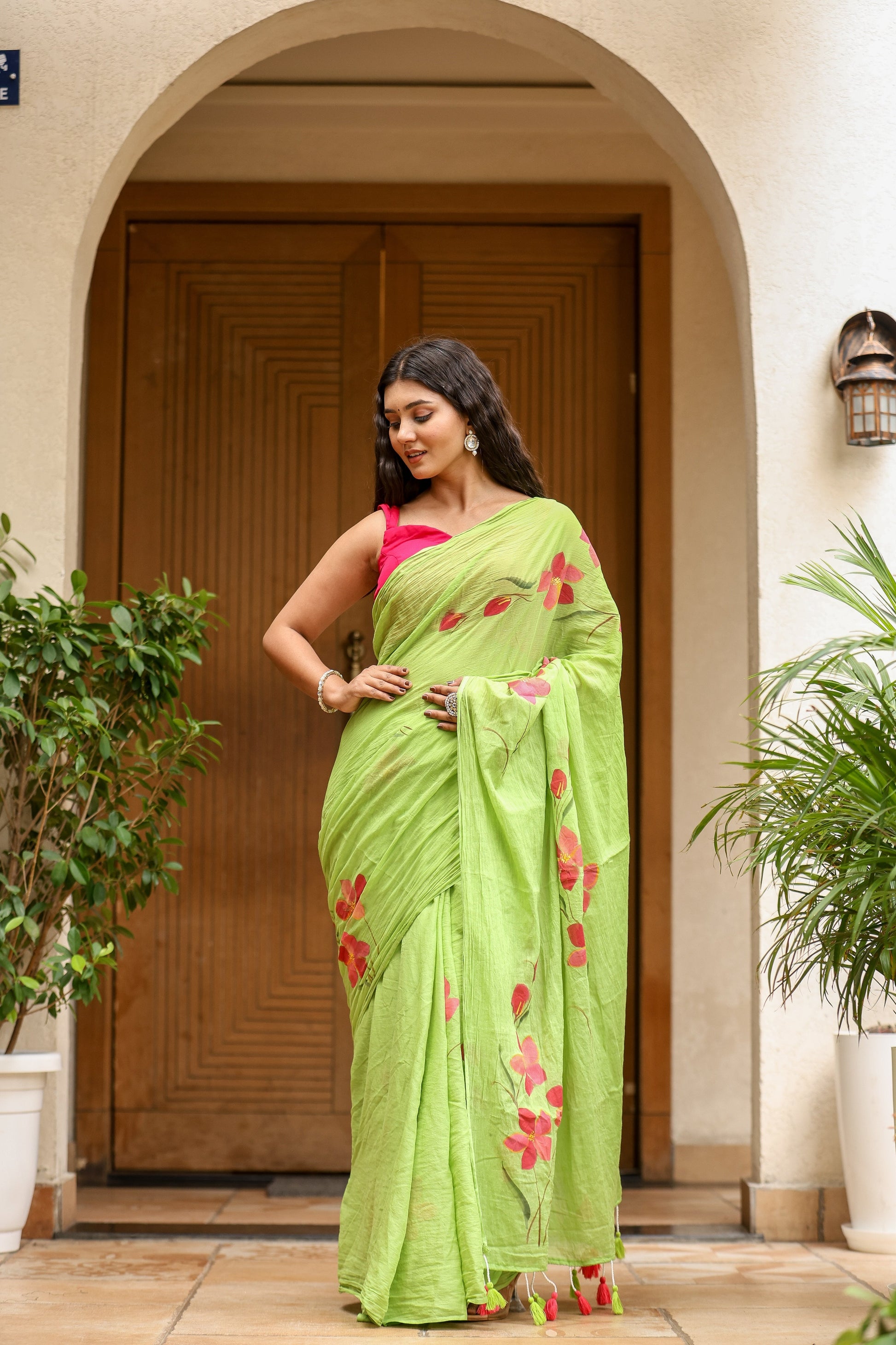 Elegant green unique designer malmal saree with floral designs, perfect for festive occasions
