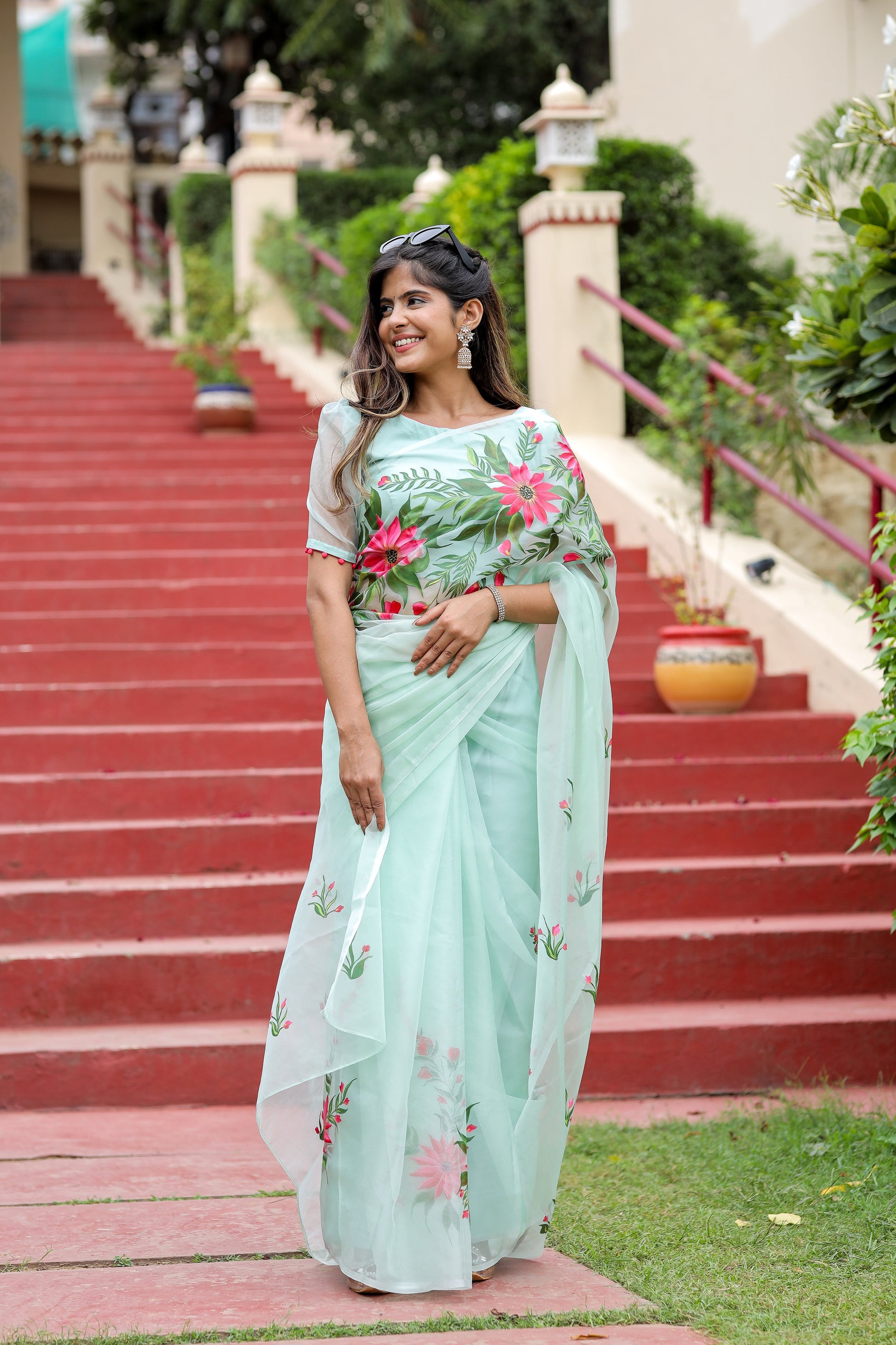 Unique designer organza saree in light green with floral embroidery, perfect for festive occasions