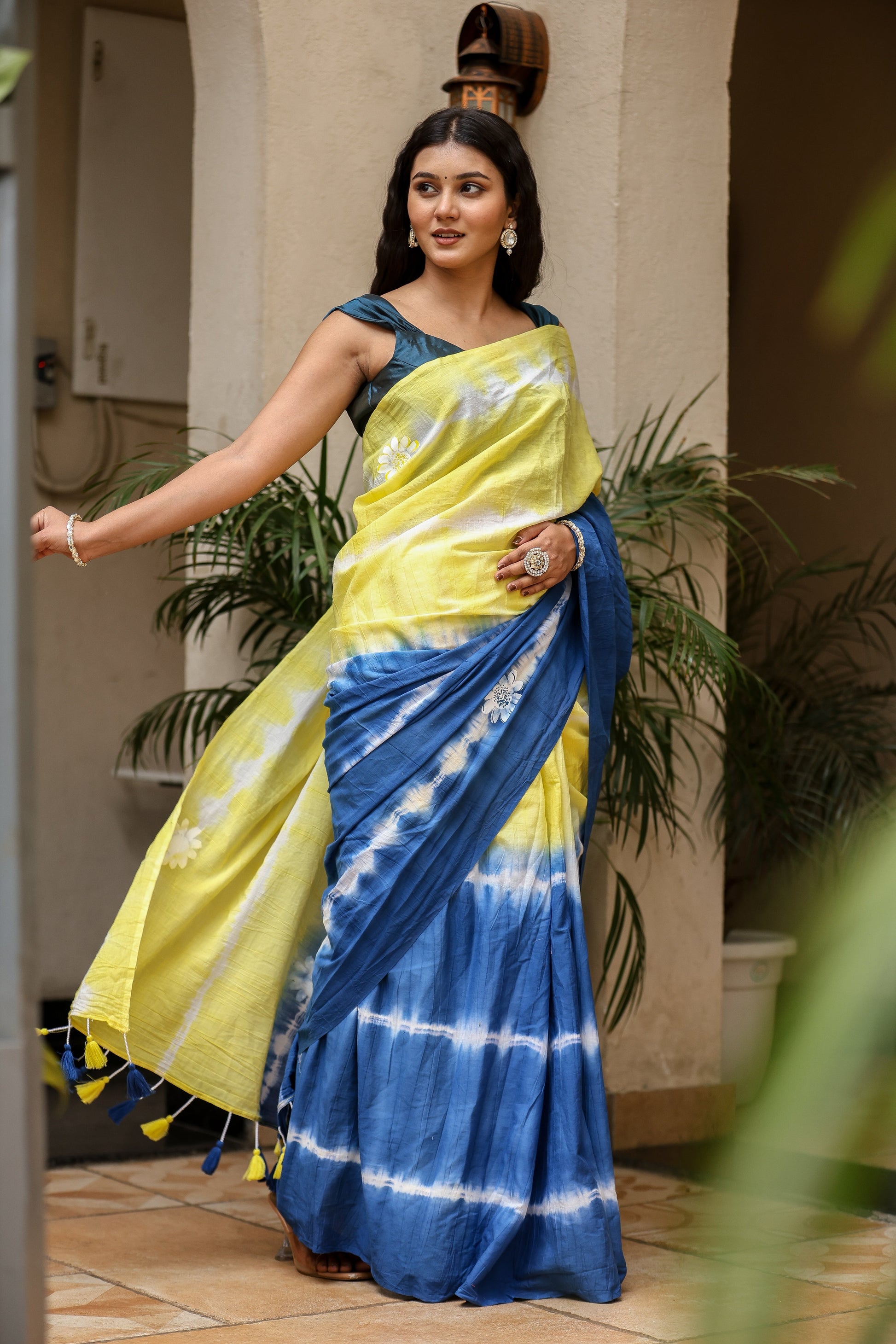 Unique designer saree for women in vibrant yellow and blue with traditional tie-dye patterns
