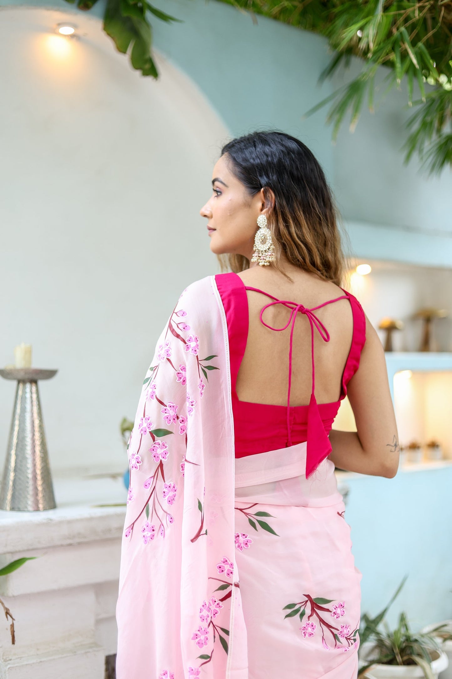 Elegant woman in a unique handpainted saree for weddings with floral patterns and a stylish blouse