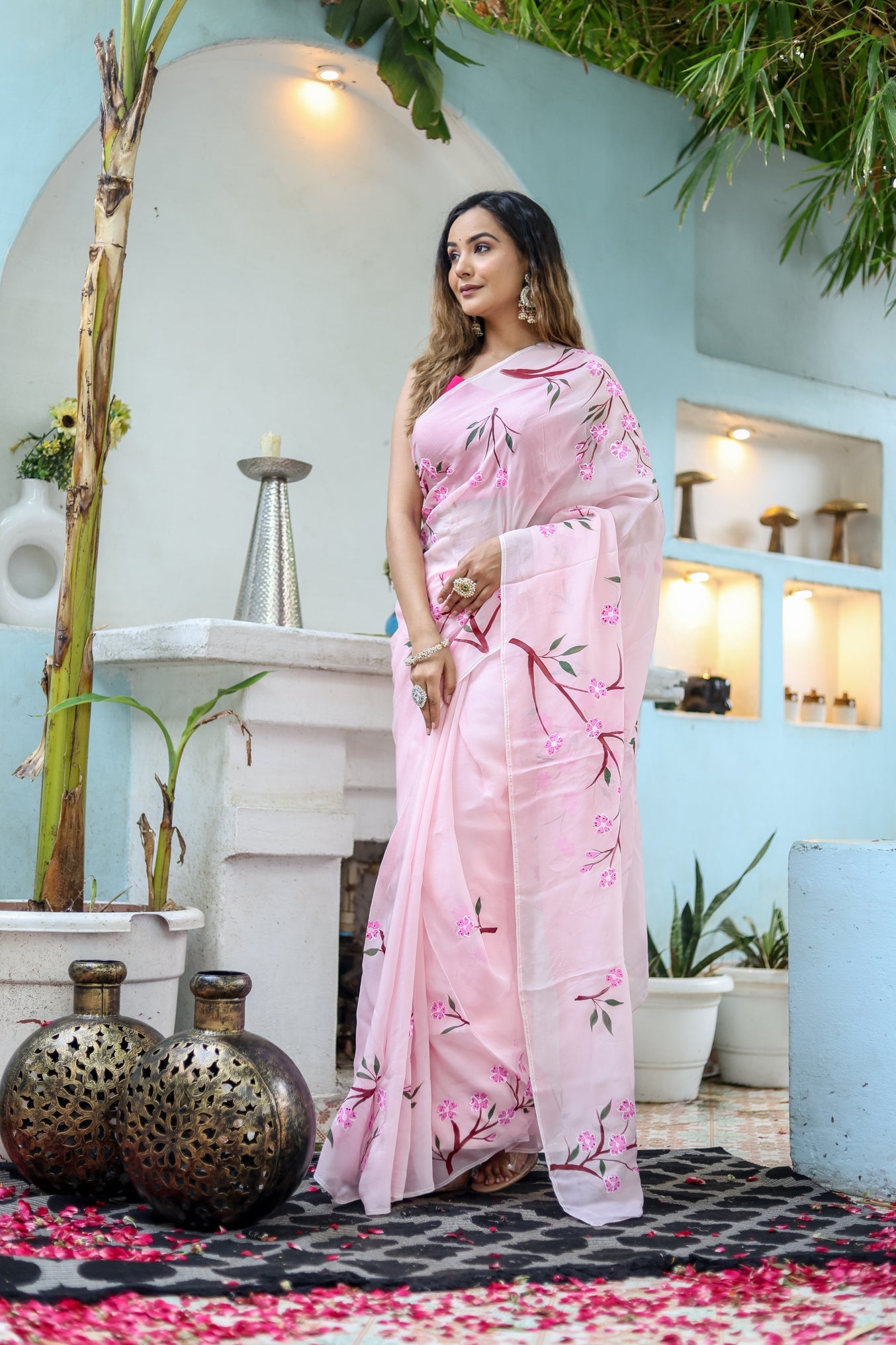 Unique handpainted saree for weddings in soft pink with floral patterns, perfect for elegant occasions