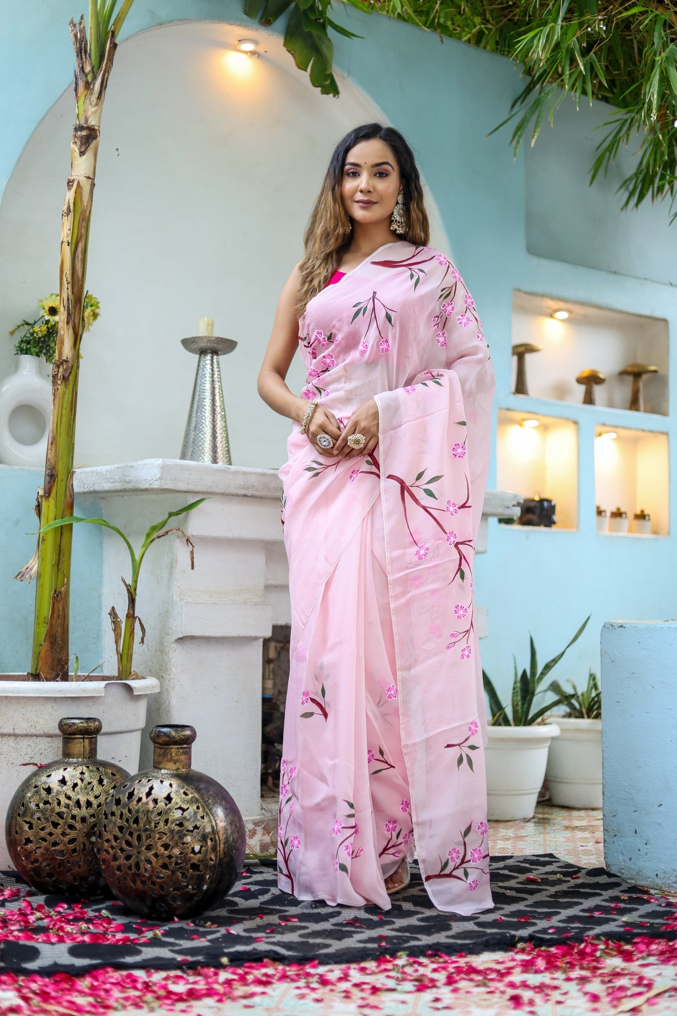 Elegant unique handpainted saree for weddings designed with floral patterns in soft pink shade