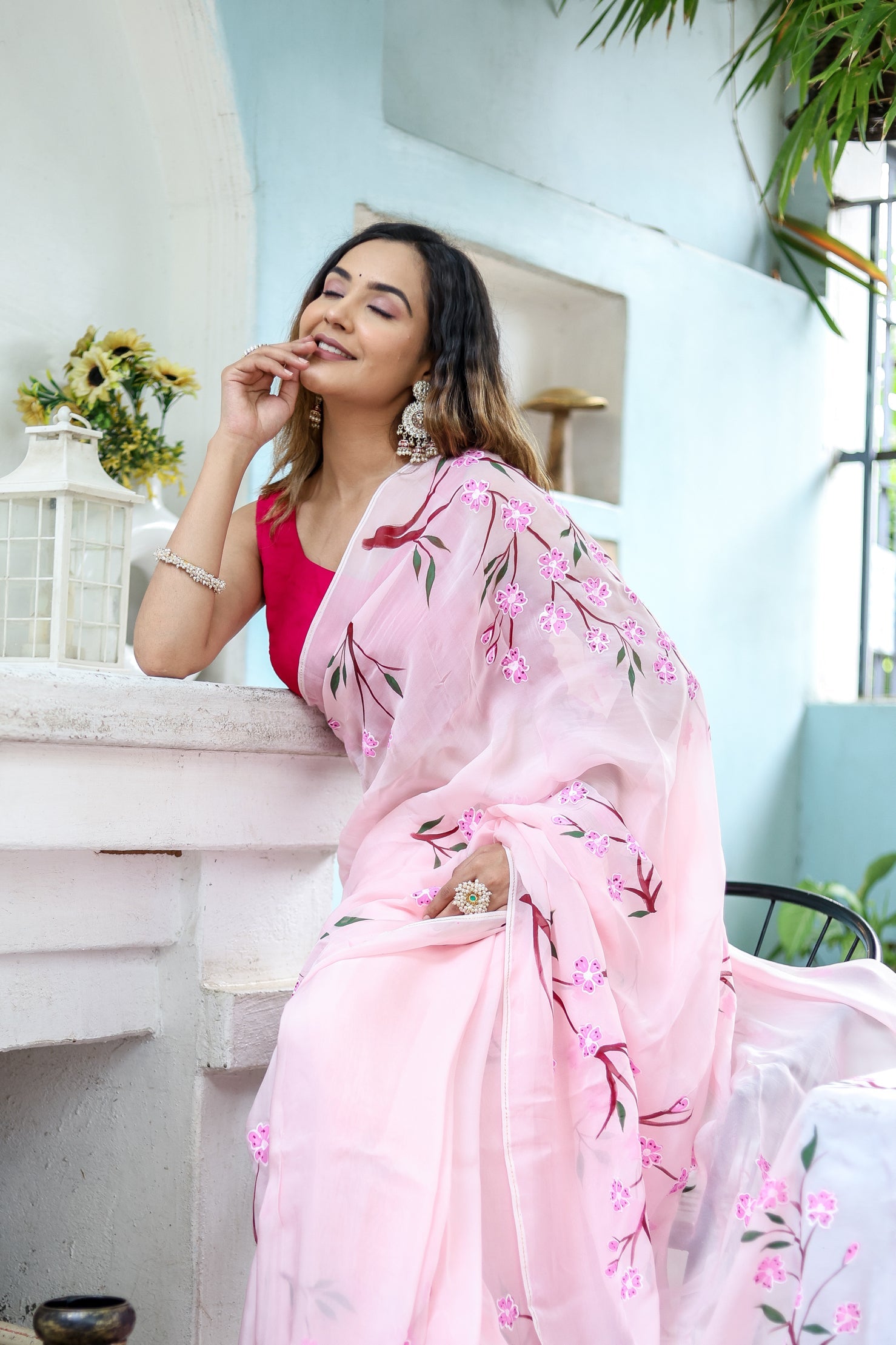 Elegant woman draped in a unique handpainted saree for weddings with pink floral designs