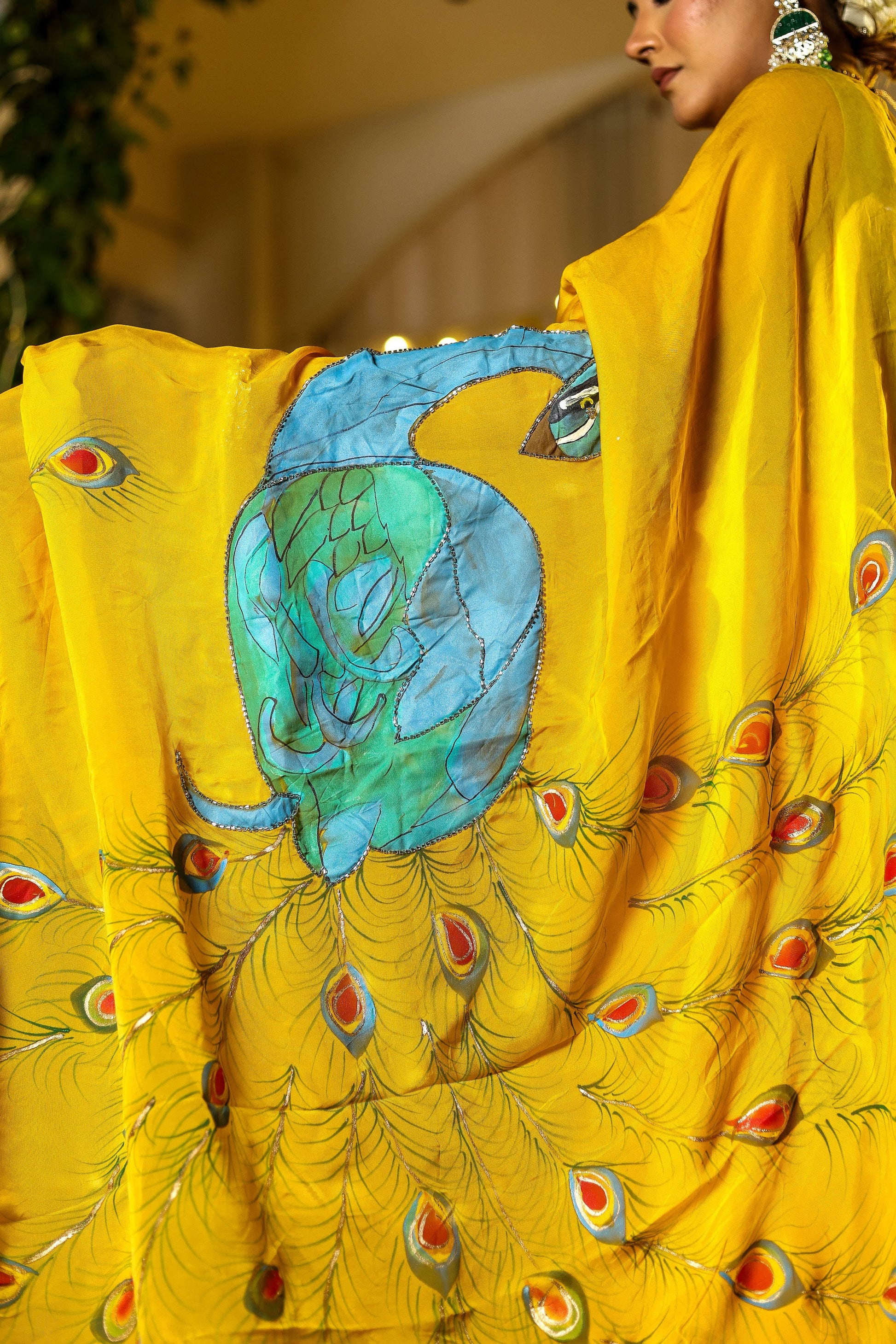 Unique Indian saree with embroidery featuring vibrant peacock designs on a yellow background