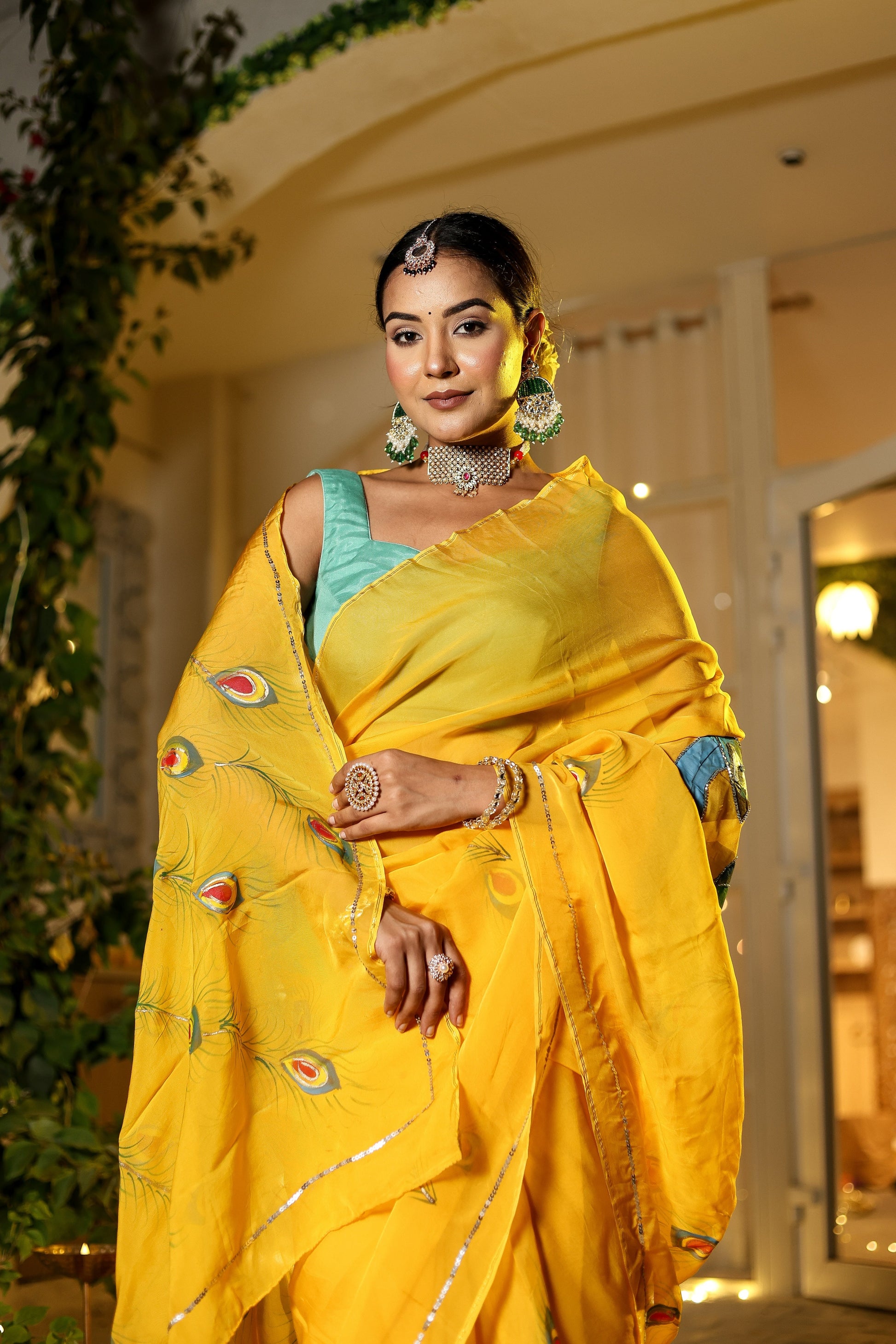 Unique Indian saree with embroidery in vibrant yellow worn by a model with traditional jewelry