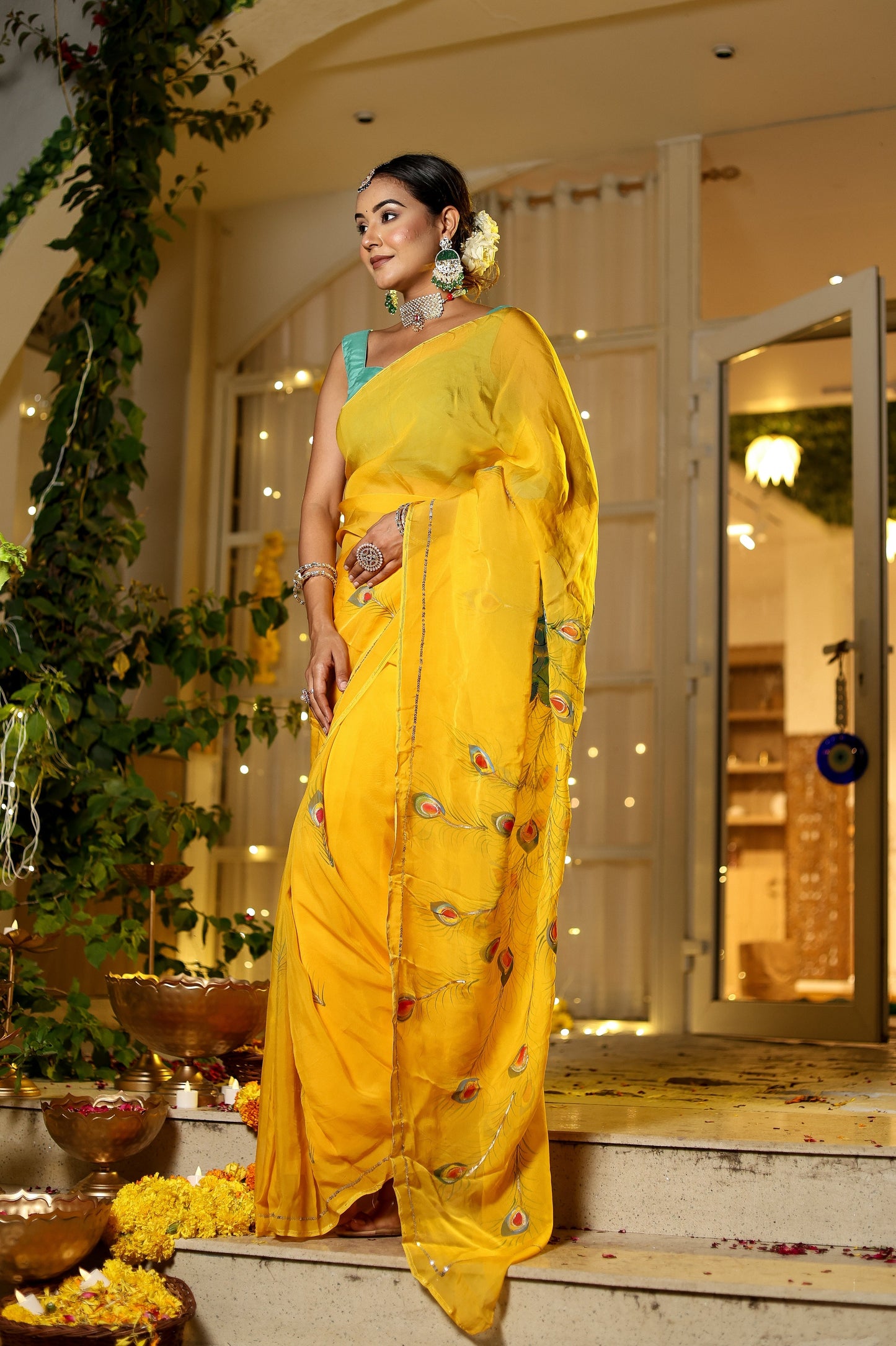 Elegant woman wearing a unique Indian saree with embroidery in vibrant yellow at a festive location