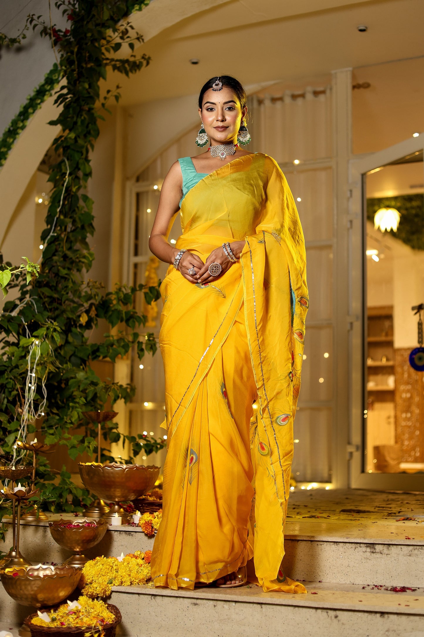 Elegant woman in a yellow saree with embroidery showcasing a unique Indian saree with embroidery