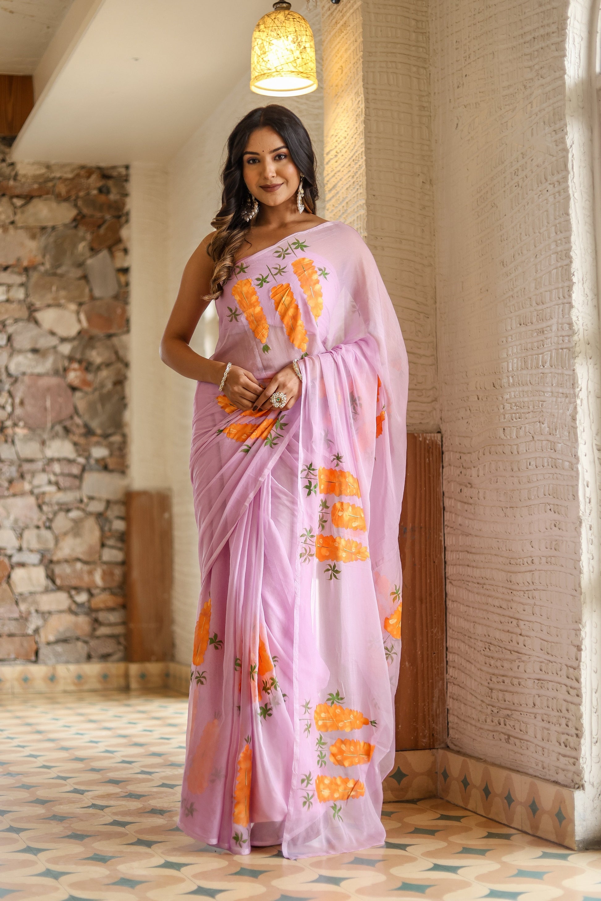 Gorgeous unique party wear saree hand painted in soft pink with vibrant floral designs