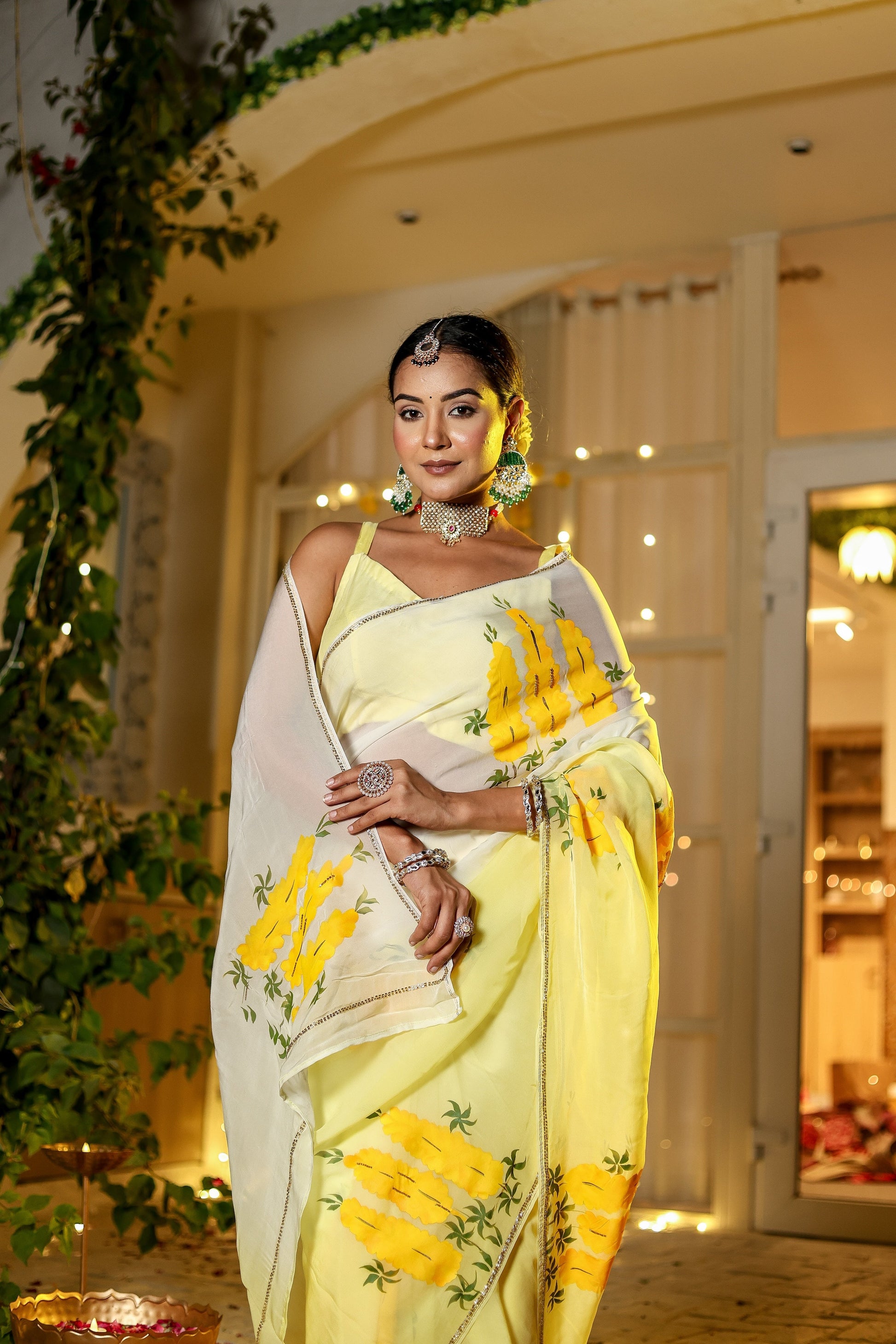 Elegant wedding organza saree yellow with floral print, styled with jewelry for festive events