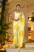 Elegant wedding organza saree yellow with floral design worn by a model in a festive setting
